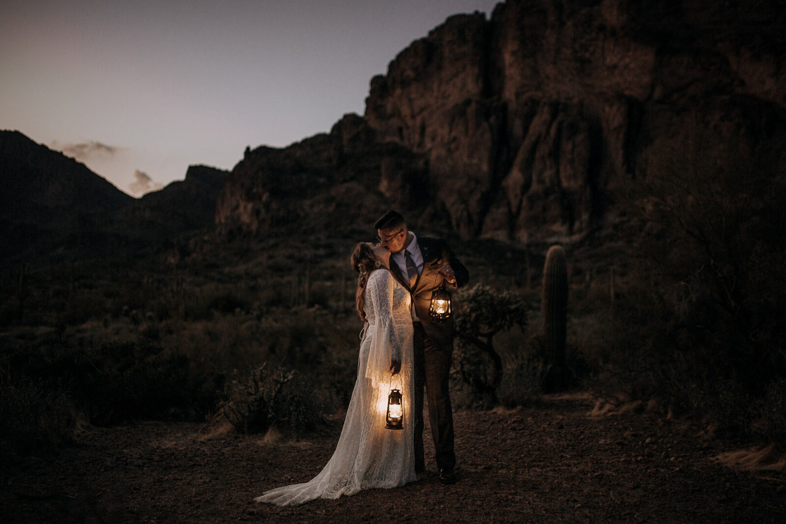 moody boho elopement in the phoenix arizona desert with cliffs and lanterns