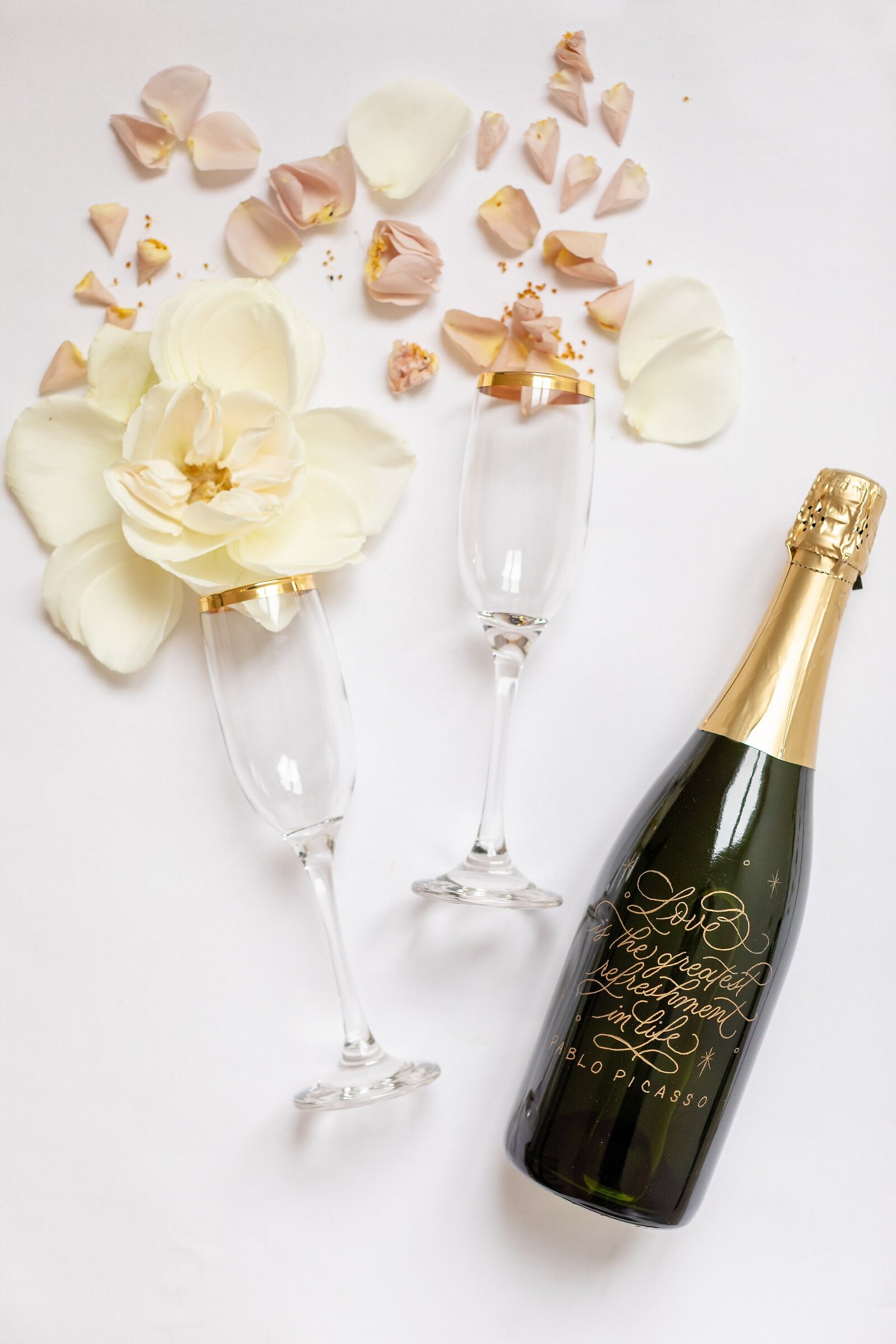 champagne-bottle-with-florals-coming-out-of-glasses-la-petite-chapelle-wedding