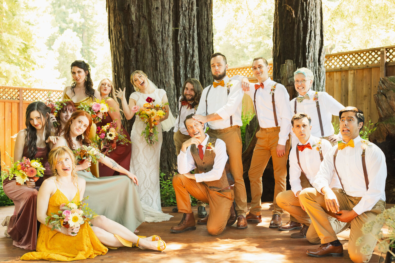 Bridal party at a colorful wedding ceremony in Santa Cruz, California in the redwood trees.