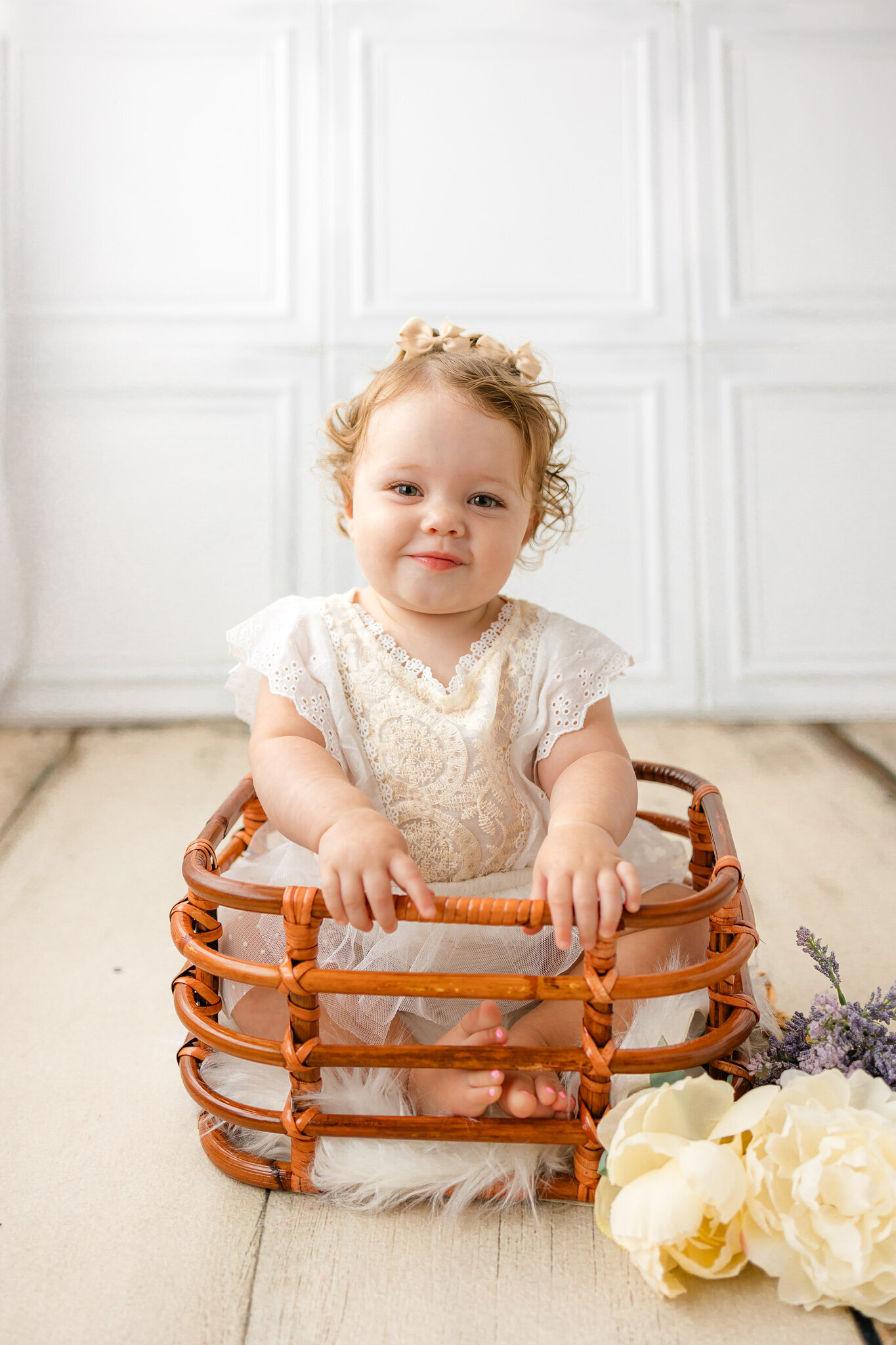 One Year old girl sitting in bamboo basket in Savannah, Ga