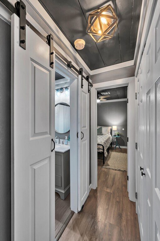 Hallway with view of the bedroom in this two-bedroom, one-bathroom vacation rental house for five located just 5 minutes from Magnolia, Baylor, and all things downtown Waco.