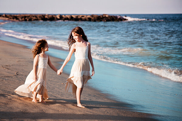 East Brunswick NJ Family Photographer Belmar Beach Sisters Holding Hands and Walking