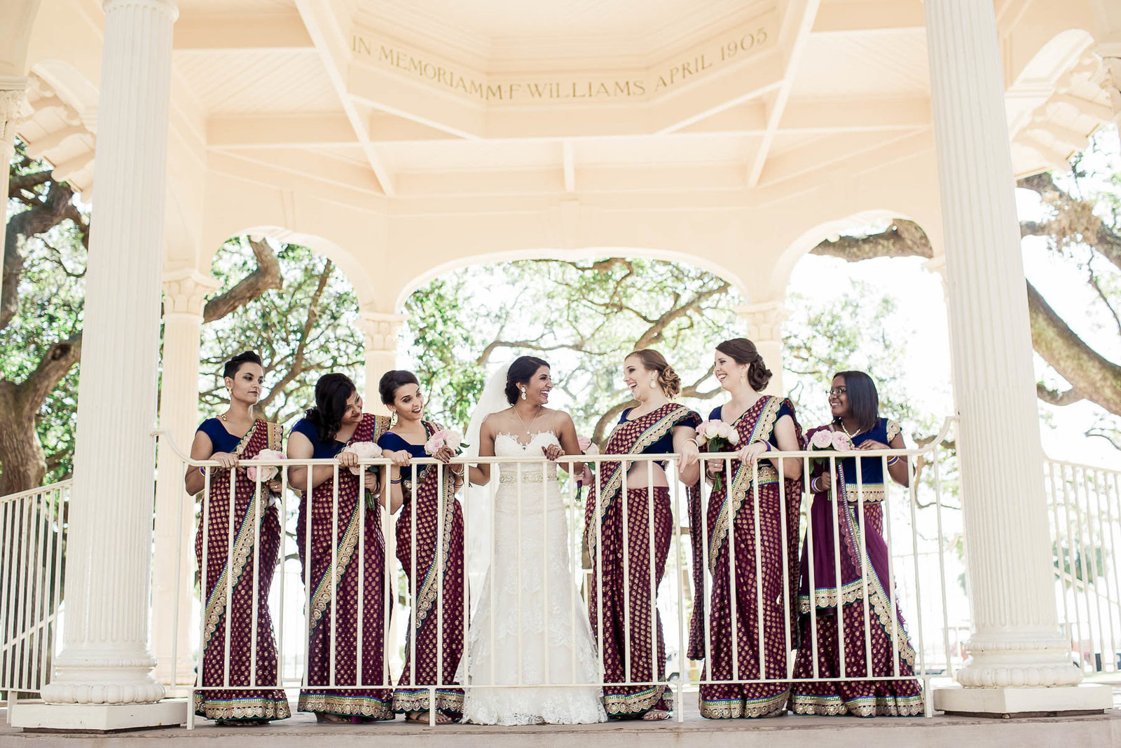 Bride poses with bridesmaids at gazebo of White Point Garden, South Carolina
