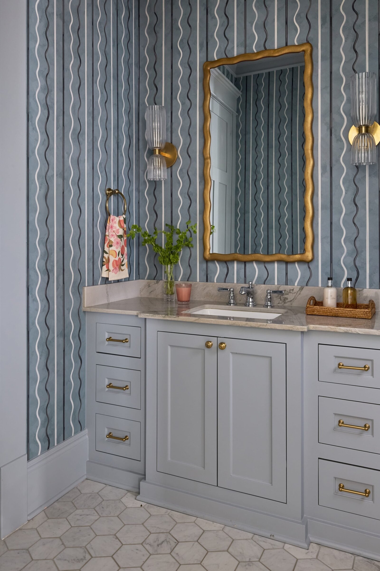 vision and hammer blue wavy wallpaper with gold trimmed mirroe