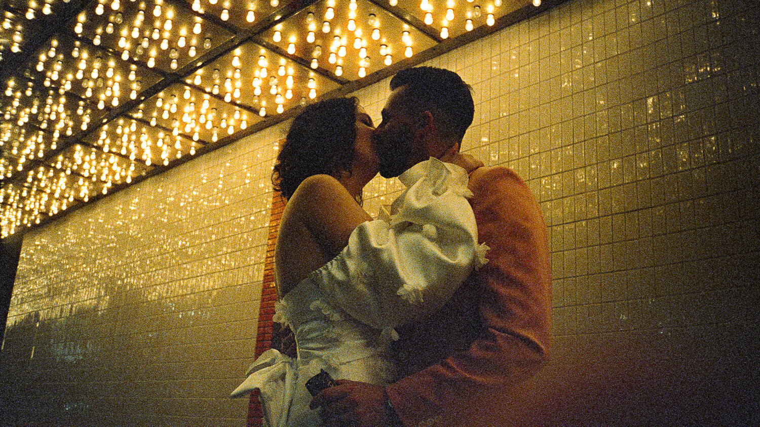 Bride and Groom kiss under the lights of Fremont Street in Las Vegas. 