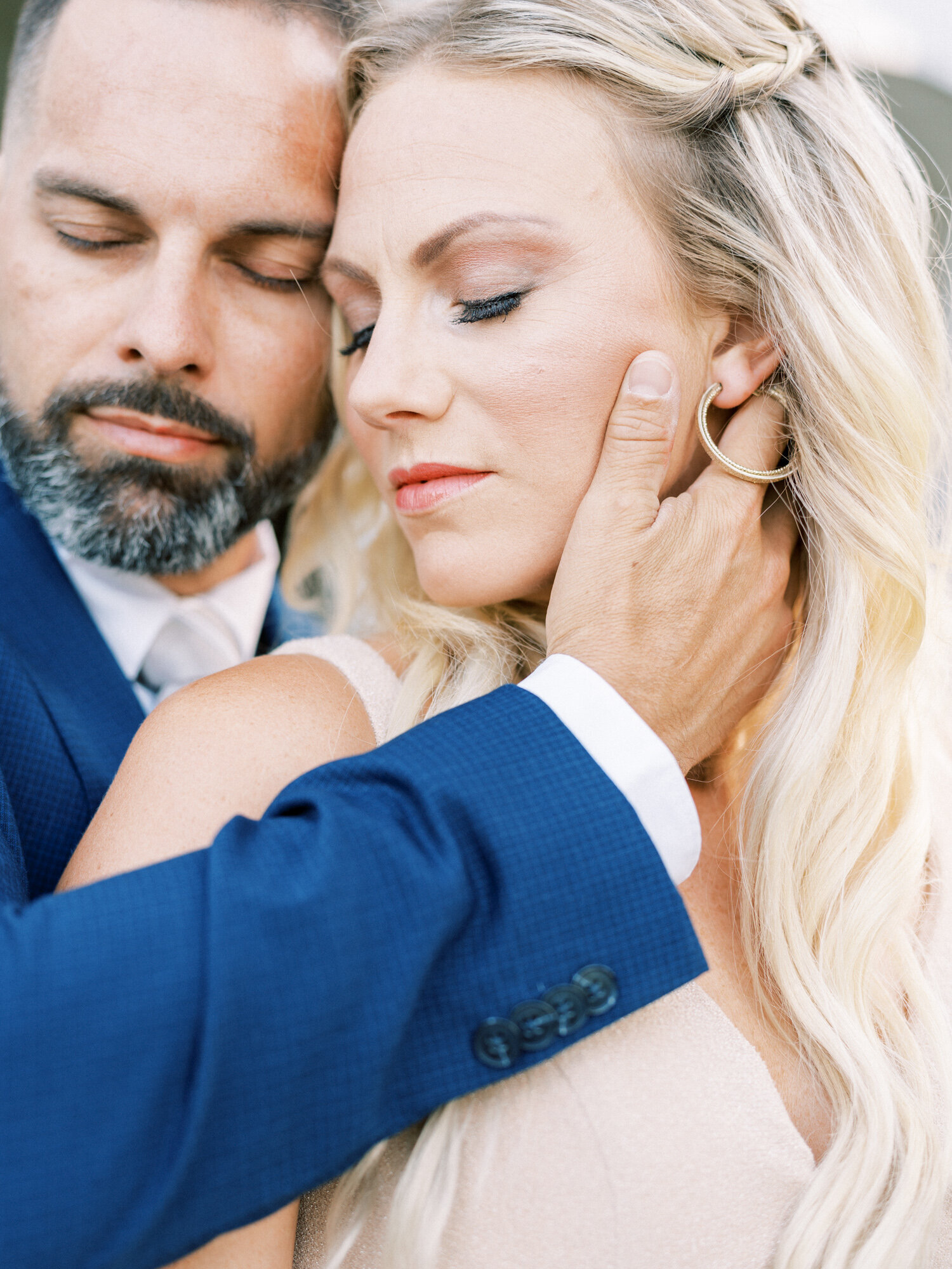 Groom holds brides face