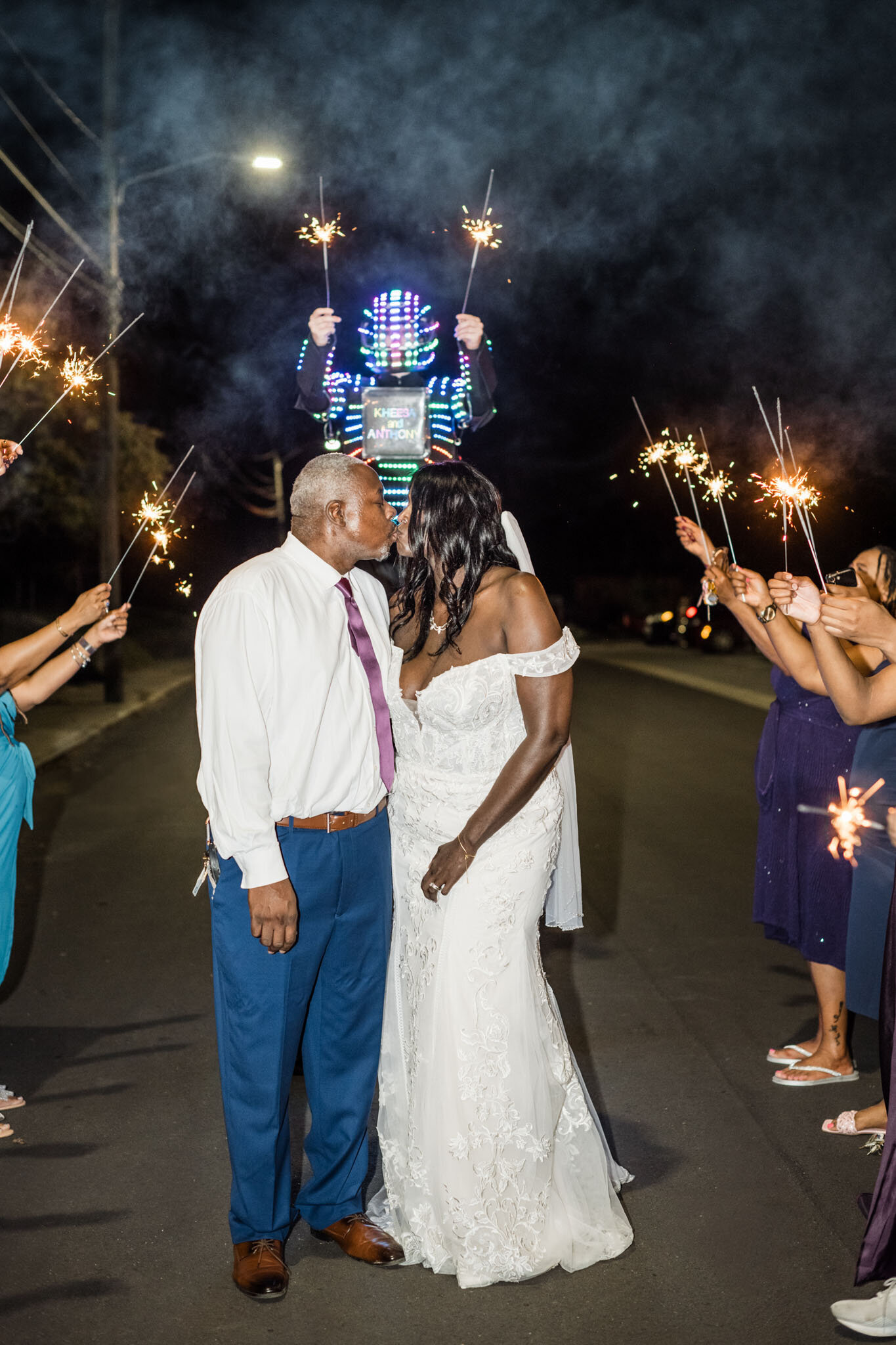 Bride and groom kissing with the sparkles around them