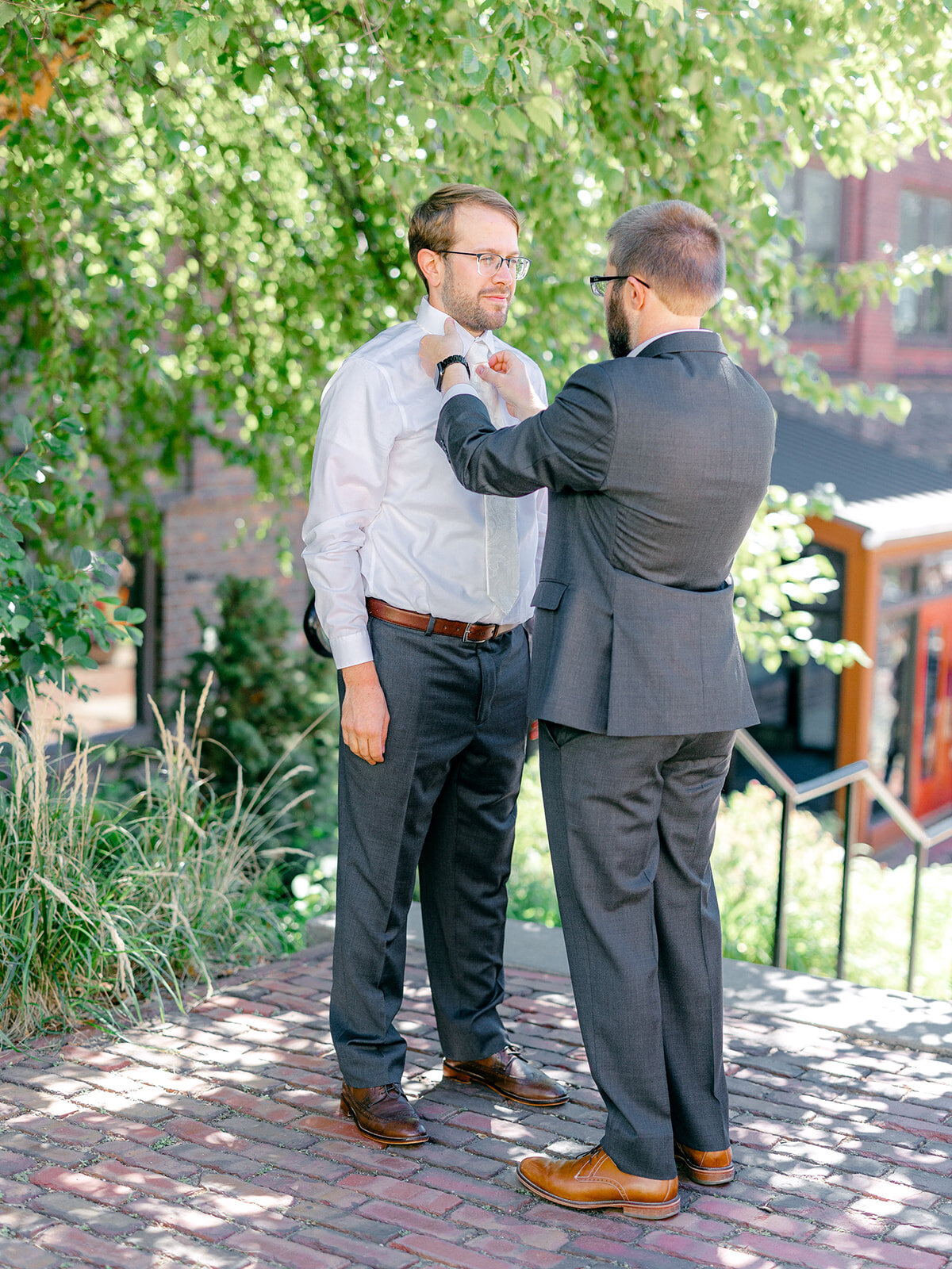 groom-getting-ready-tie-white