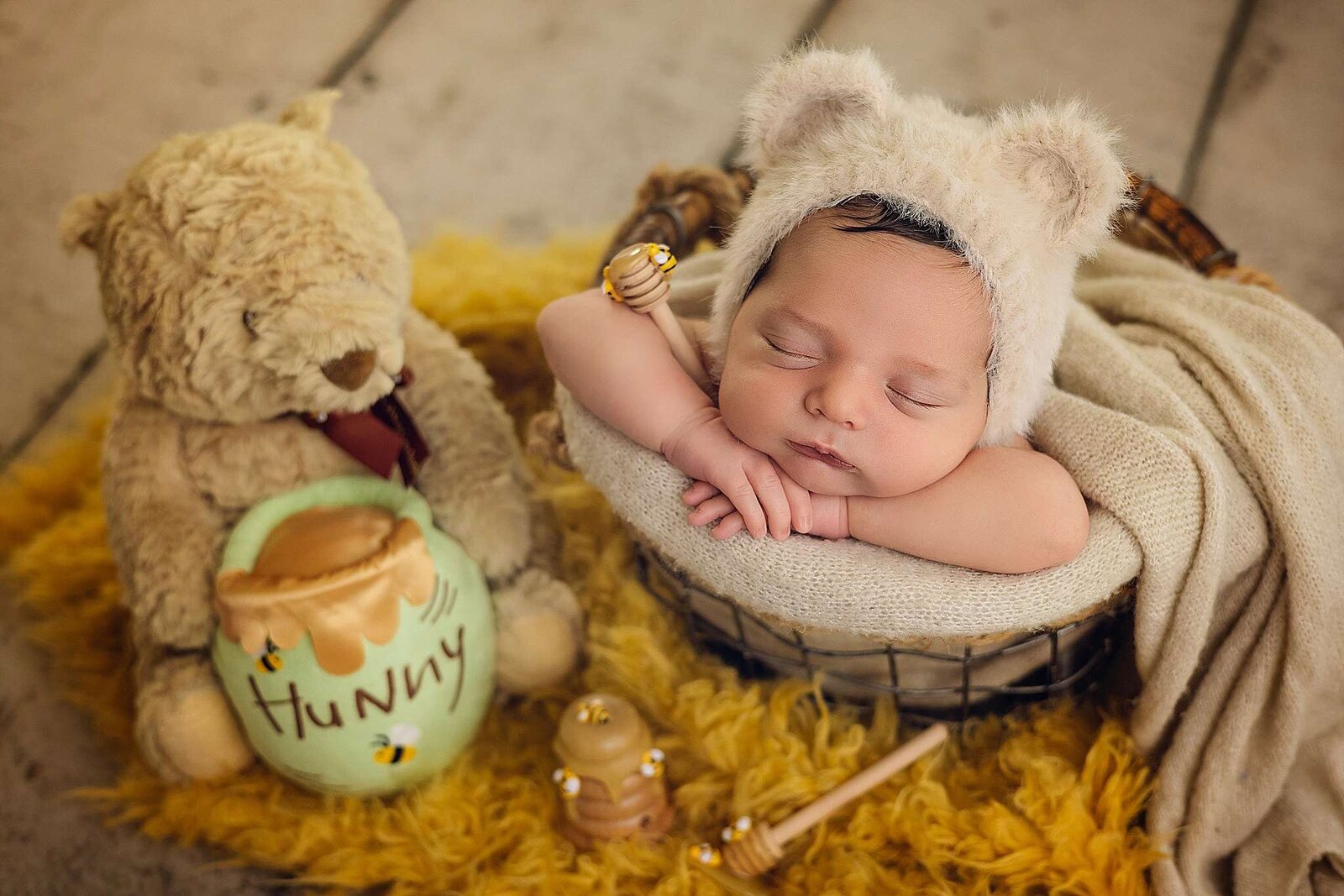 Adorable newborn baby resting in a basket with a teddy bear, taken during an in-home session by Orlando photographer Bia Schaefer.