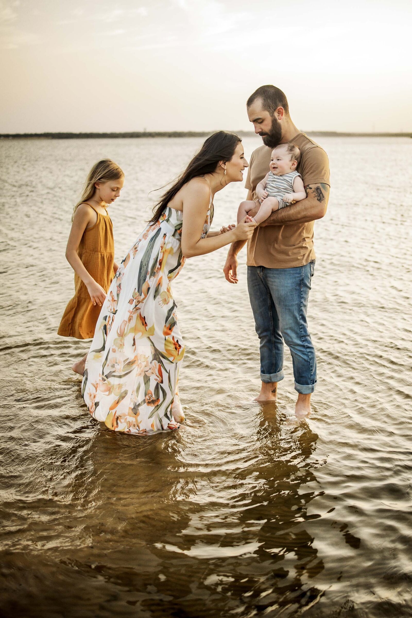 mother kisses her baby at the lake near Southlake Texas