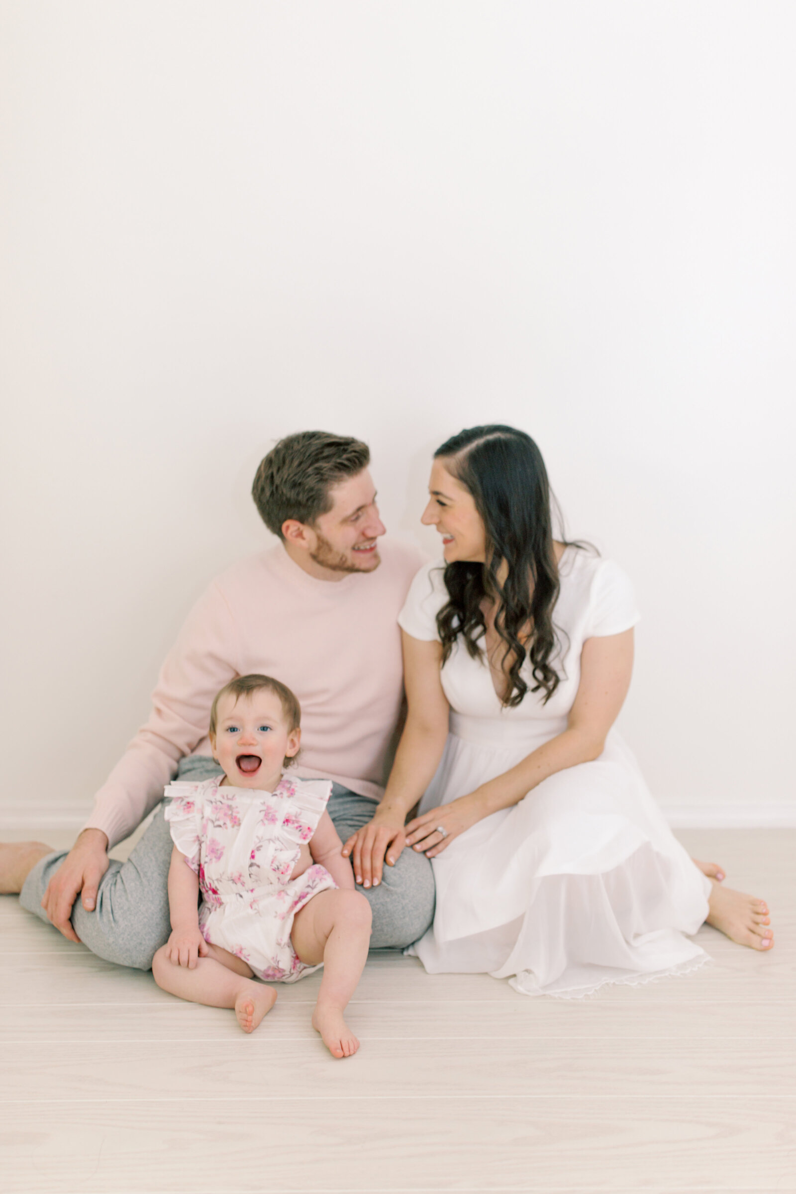 family smiling at each other in photography studio by spokane wa family photographer