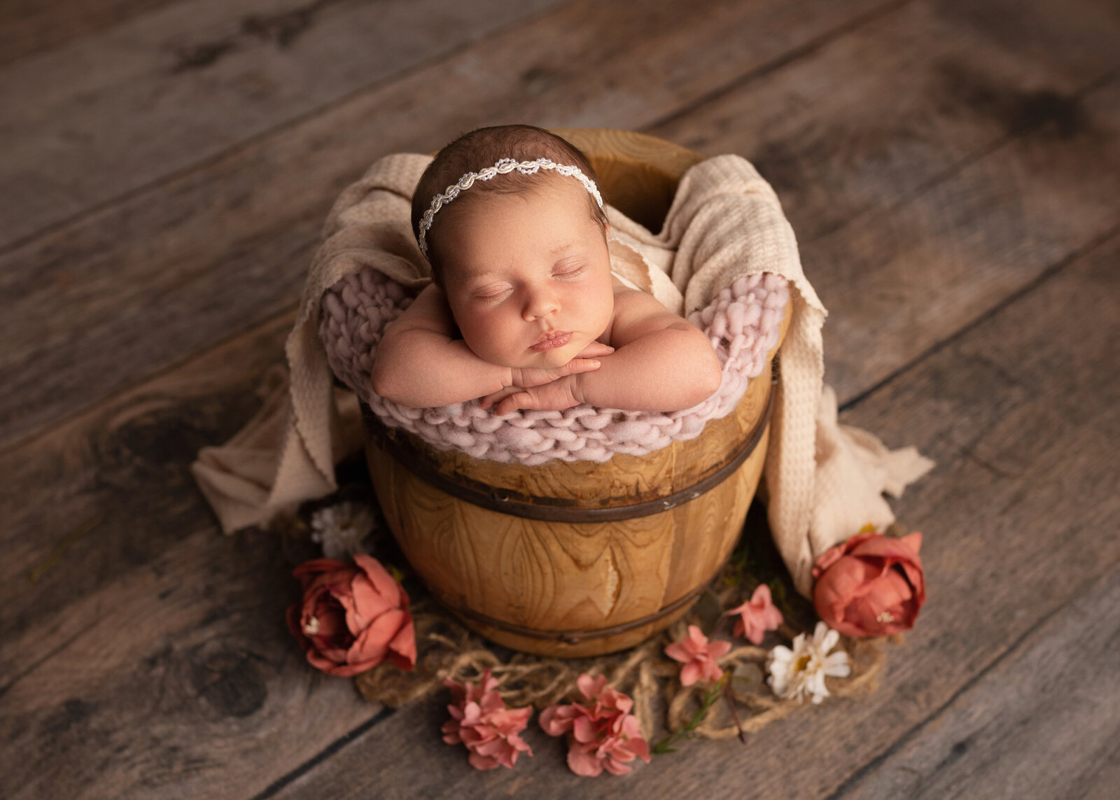 Baby girl in bucket with flowers