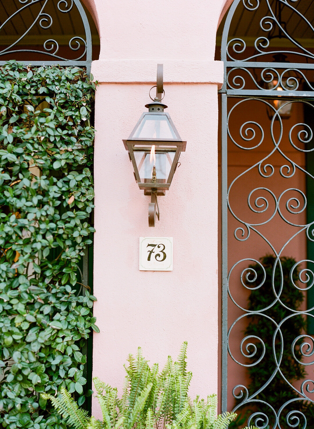 Gas Lantern and Number 73 Marker on Pink wall in Charleston