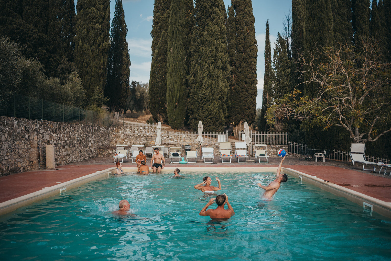 guests playing polo in pool in Tuscany