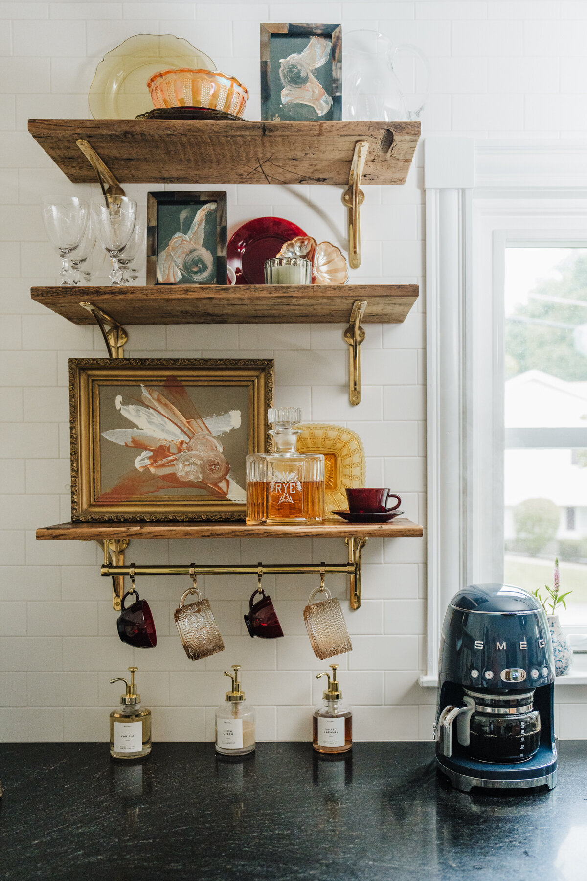 styled shelves in kitchen hold artwork