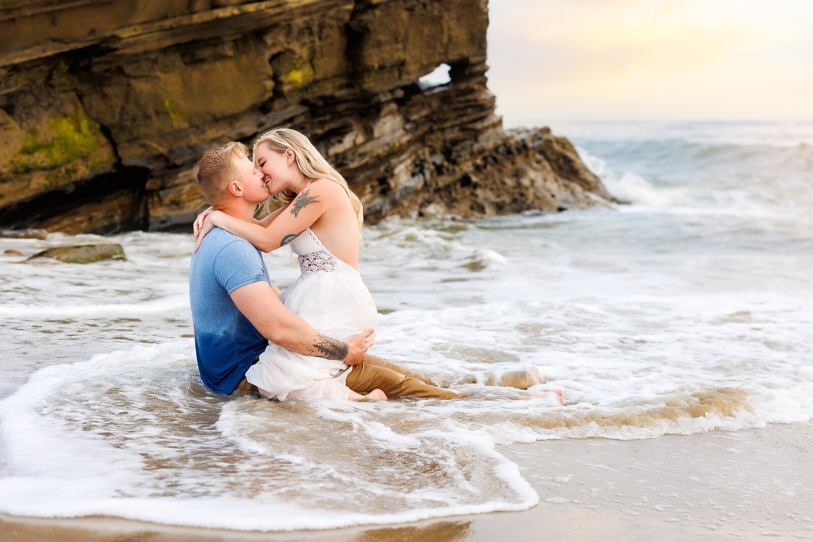 Couple kissing in the water in Ocean Beach California