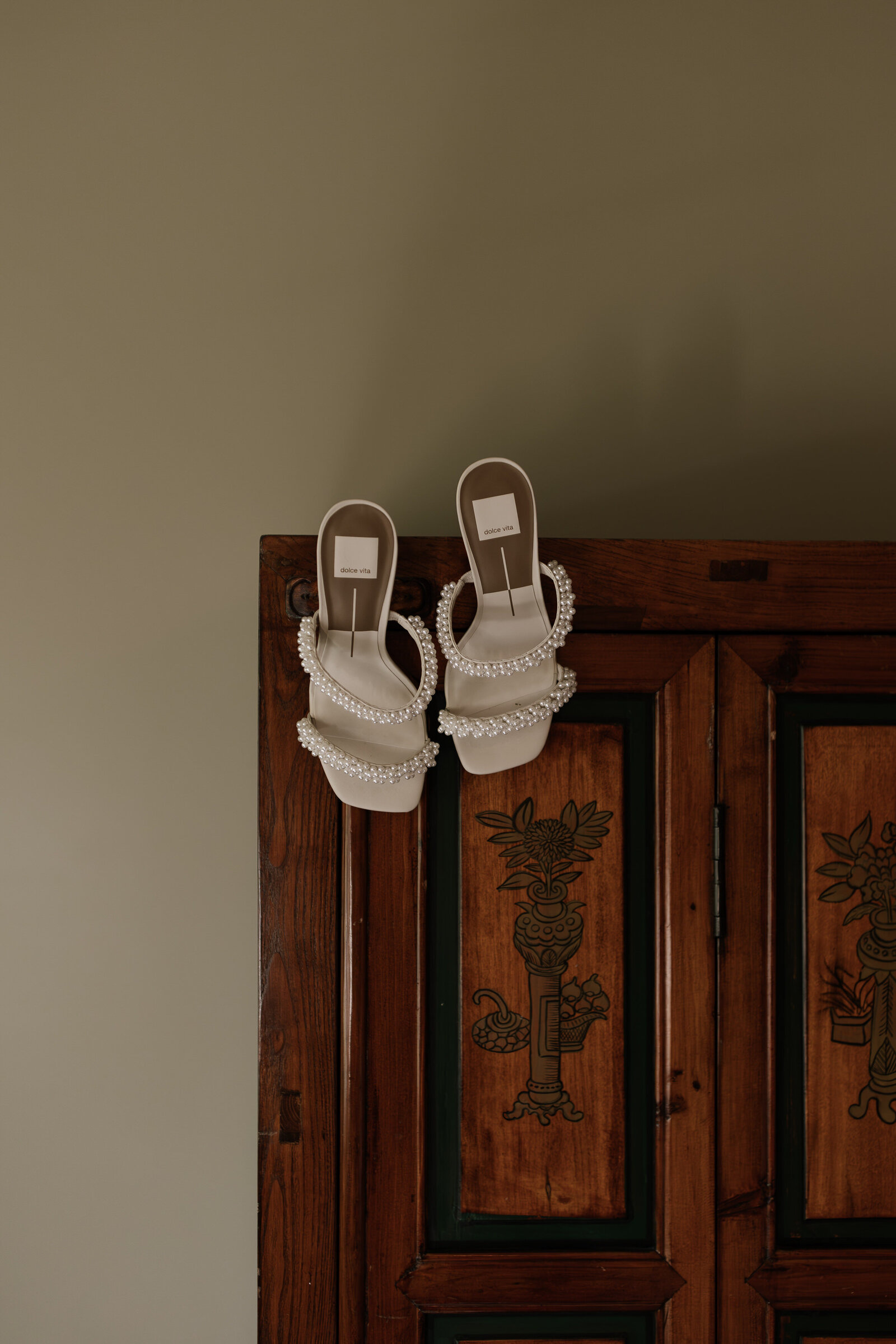 Bride heels placed on wardrobe in getting ready suite at Dawn Ranch wedding venue in Northern California