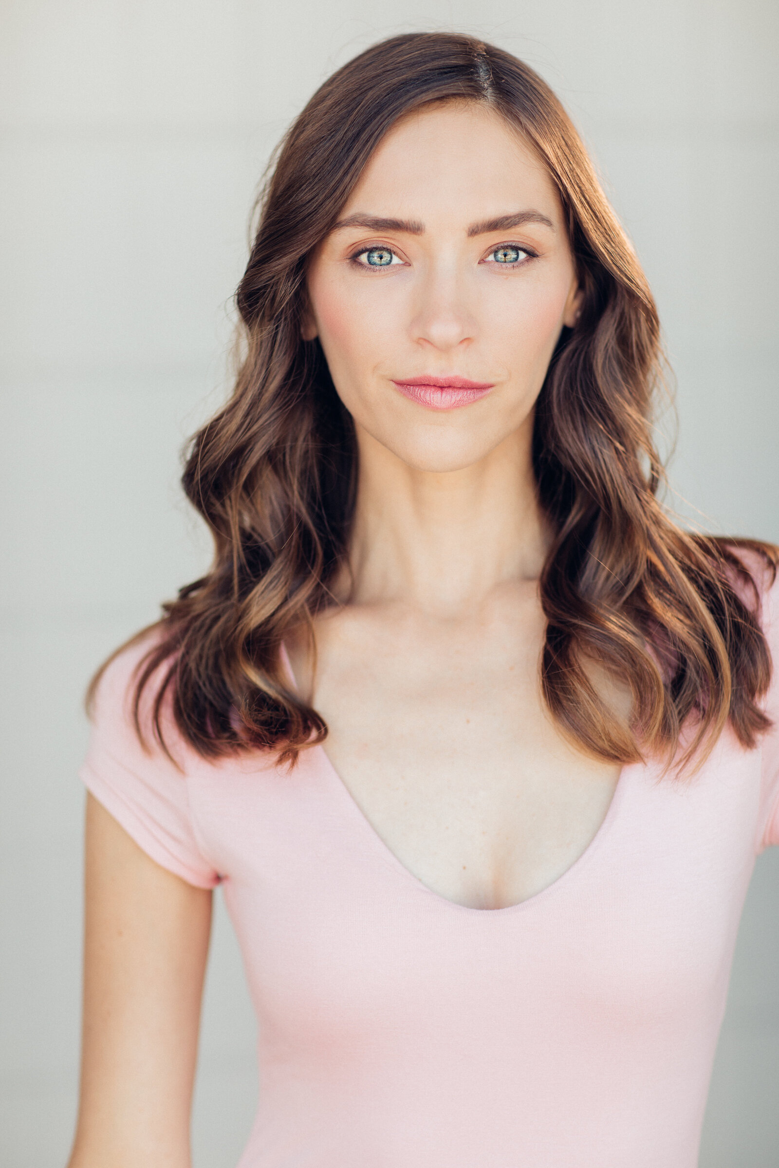 Headshot Photograph Of Young Woman In Pink V-Neck Shirt Los Angeles