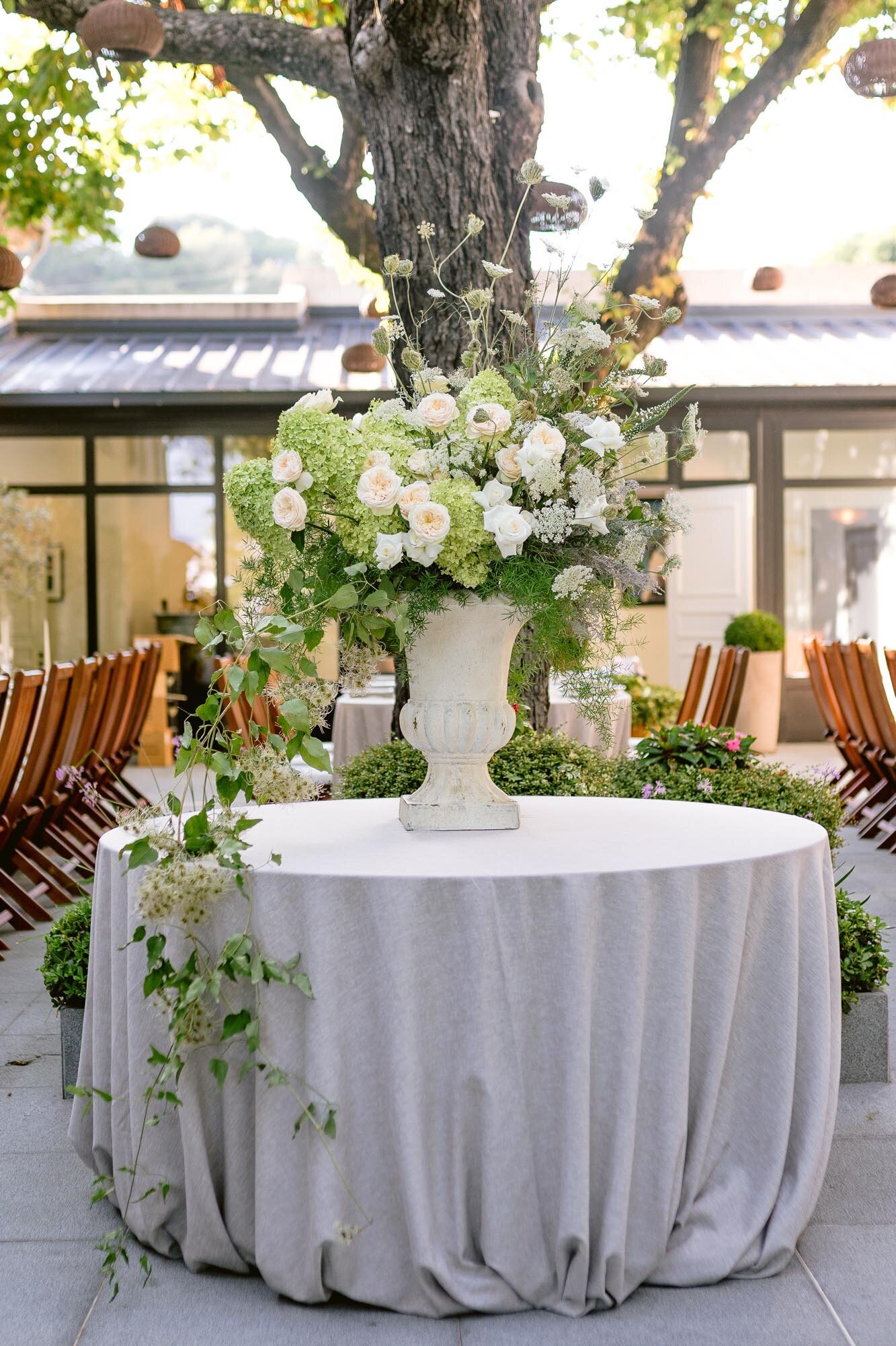 A green and white floral medicis for  a outdoor wedding