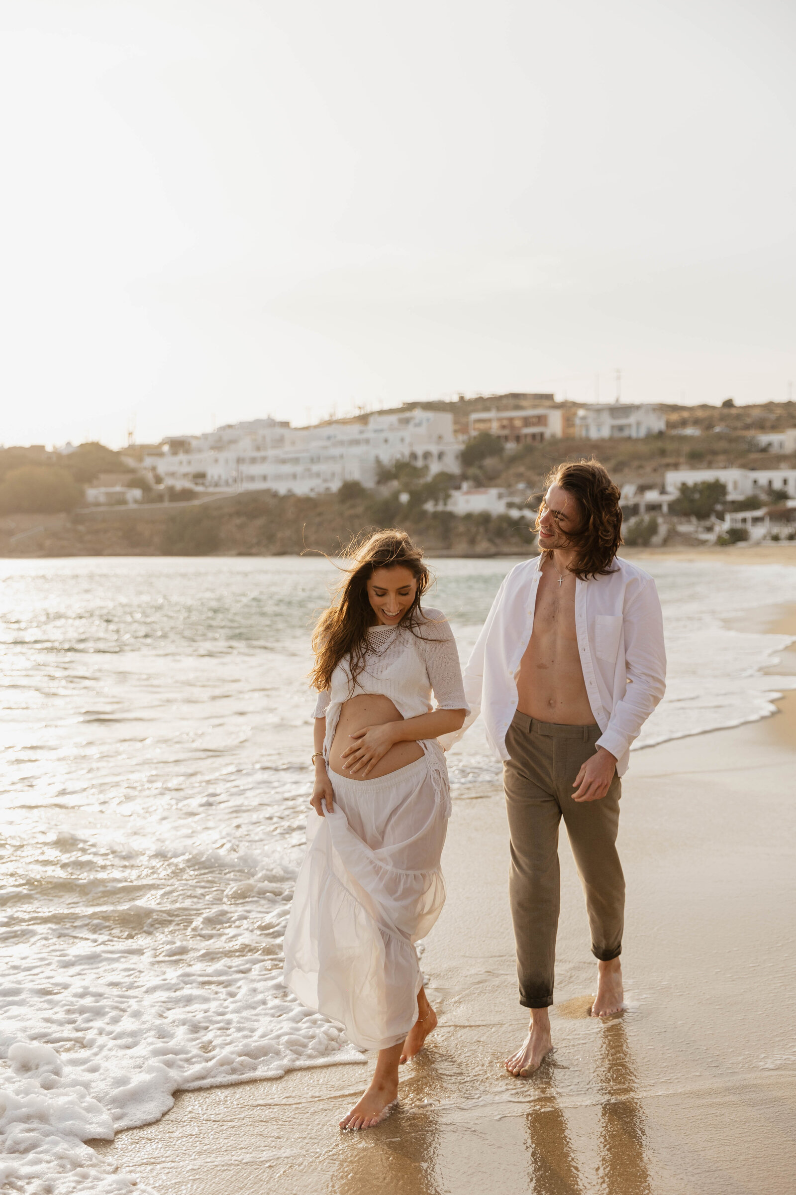 Elopement photographer capturing the newlyweds’ joyous celebration with a breathtaking view of a Greece beach.