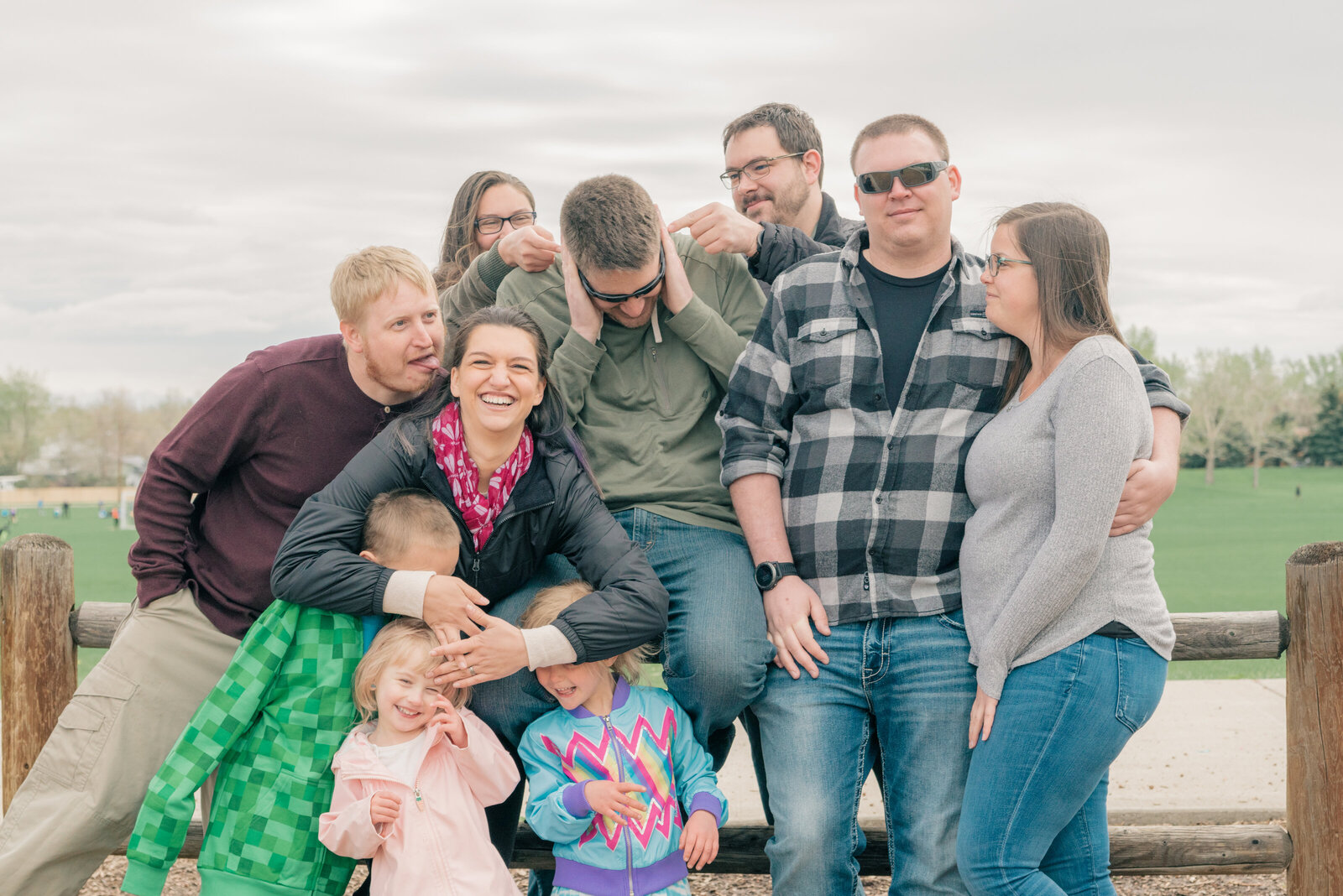 Heartwarming scene as Amy Hodder's kids and grandkid sit together on a fence at Addenbrooke Park in Lakewood, Colorado