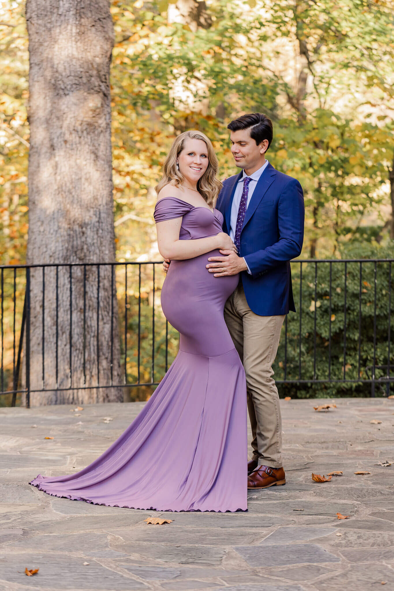 A couple posing at a park in Centreville, VA for their maternity photography session.
