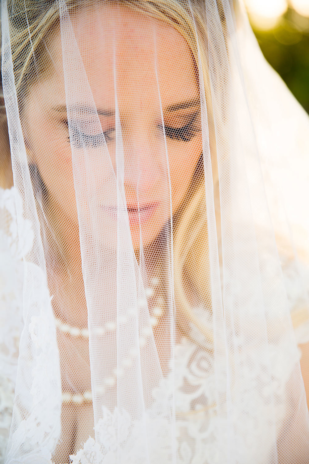 Candid bridal portrait through the veil