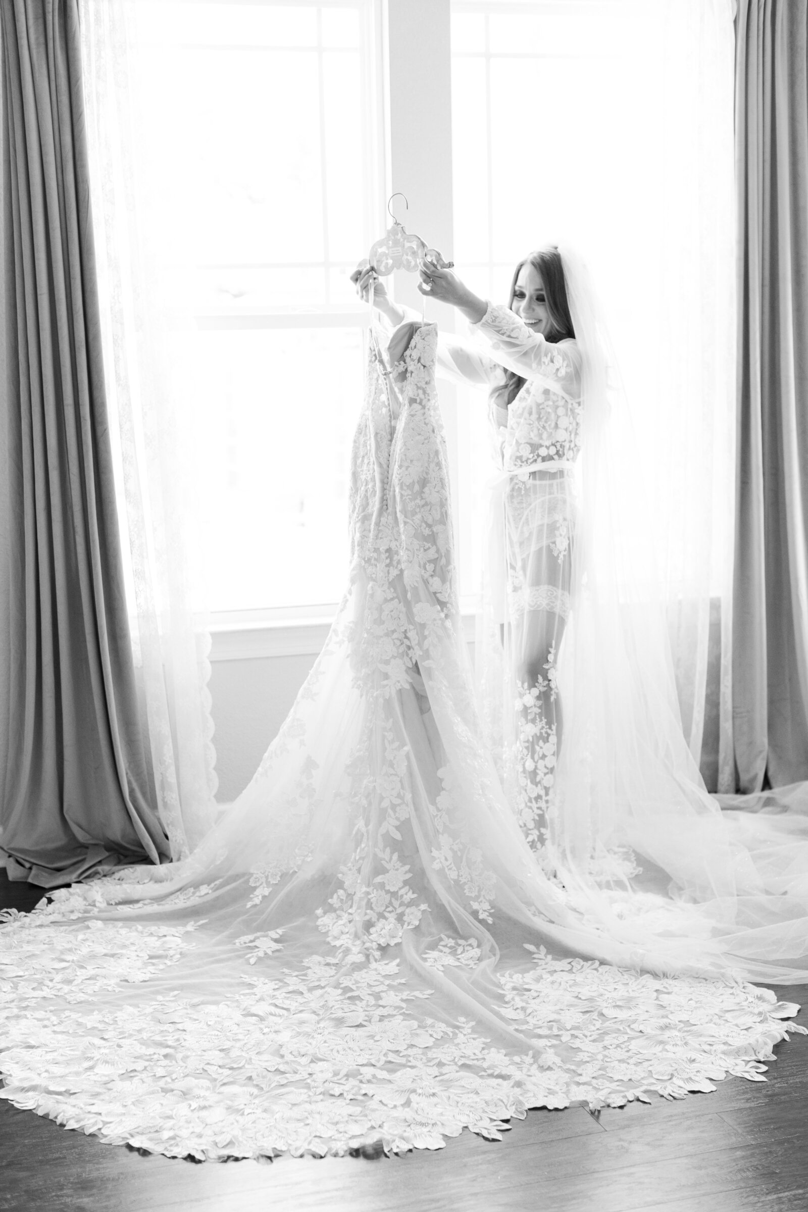 bride holding her wedding dress boudoir