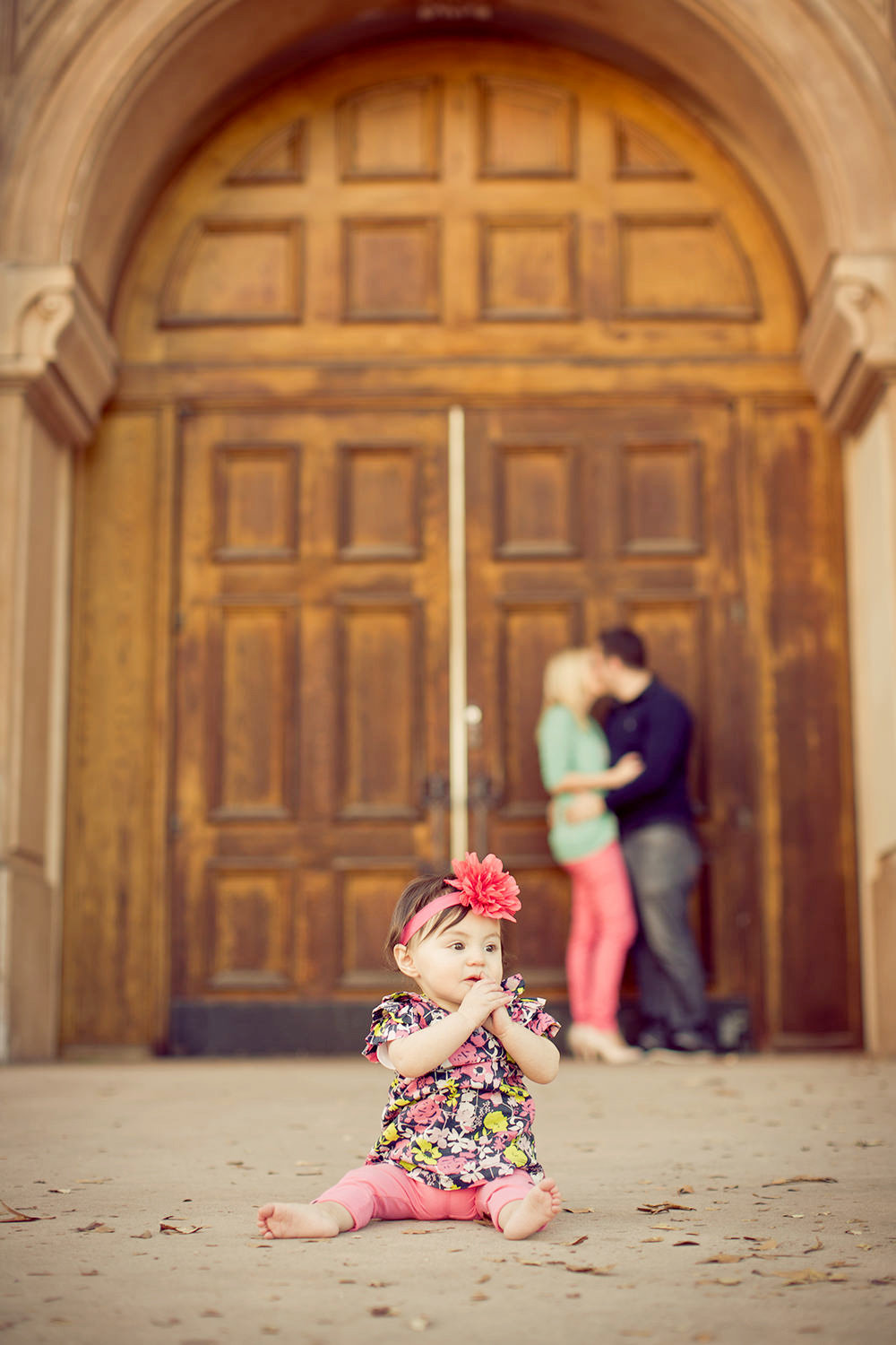 san diego family photography | parents kissing in the background with daughter in the front