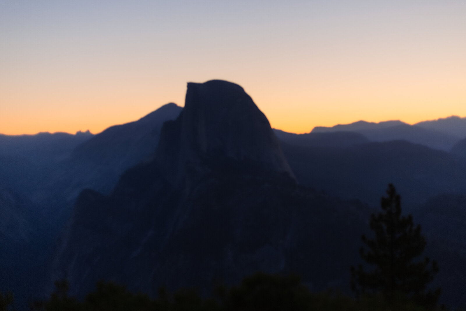 A wedding proposal between two hikers at sunrise in front of Half Dome in Yosemite National Park.