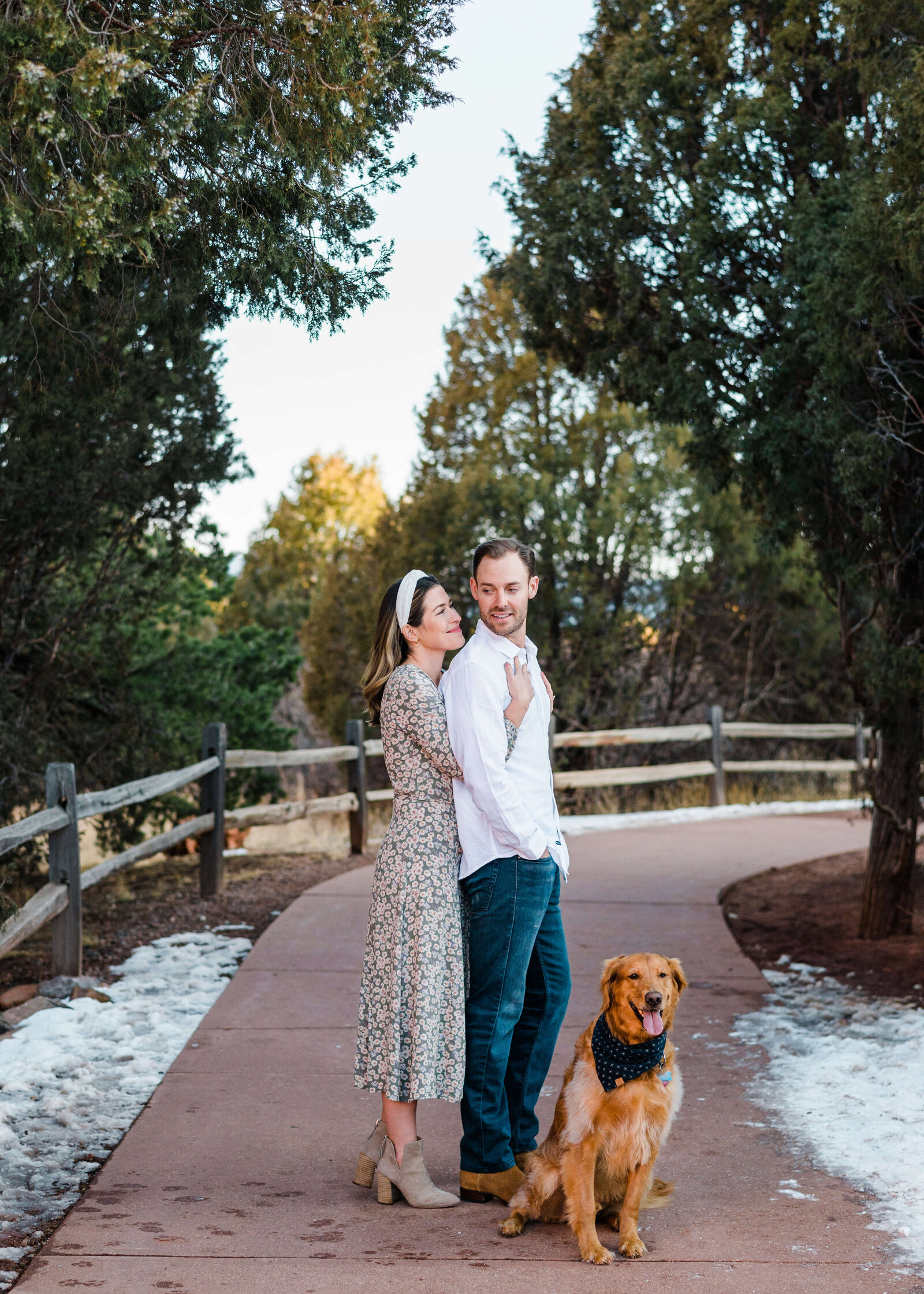Man woman and dog at a park during engagement photo session