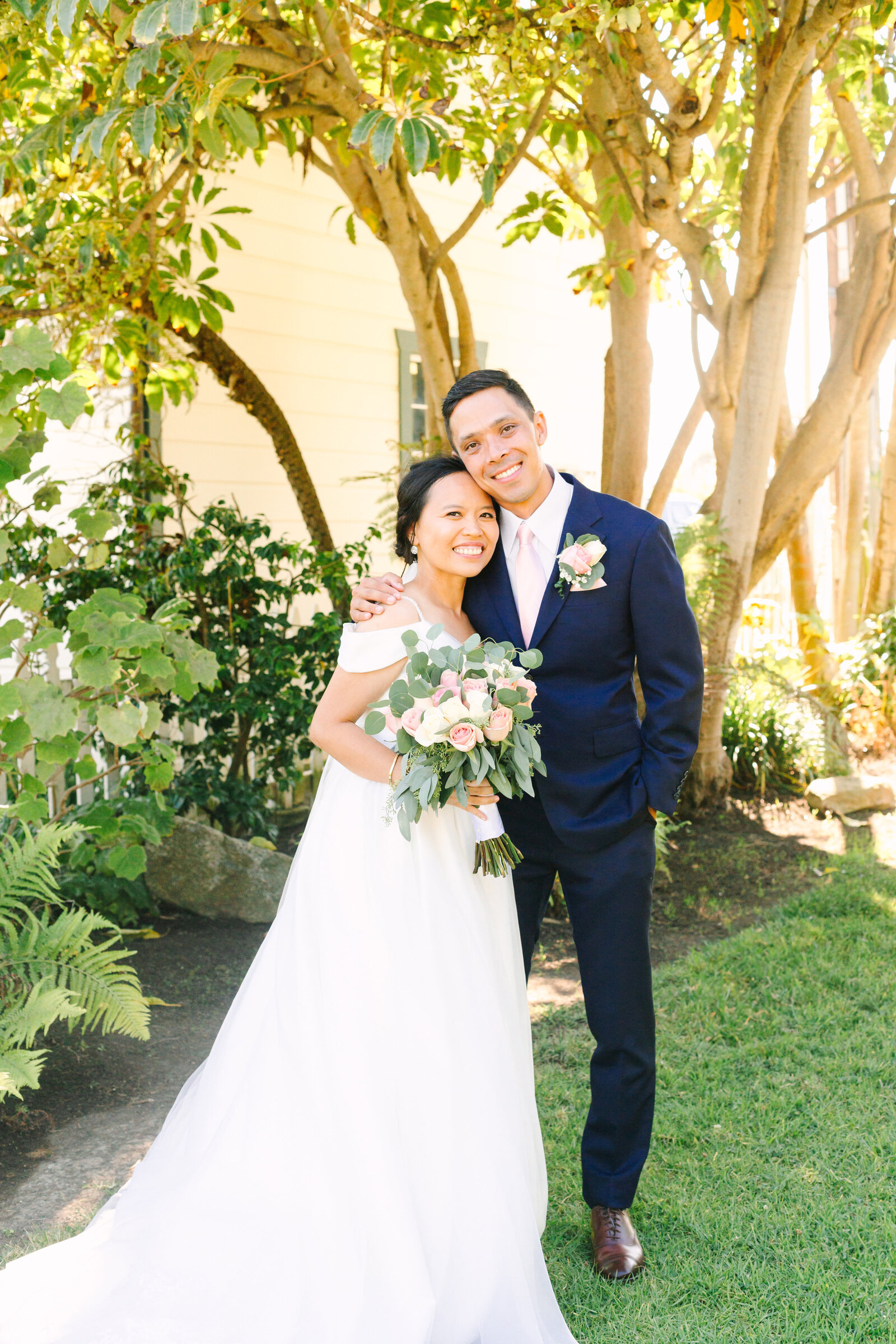 A newlywed couple holds hands after their wedding ceremony in San Pedro, Ca.