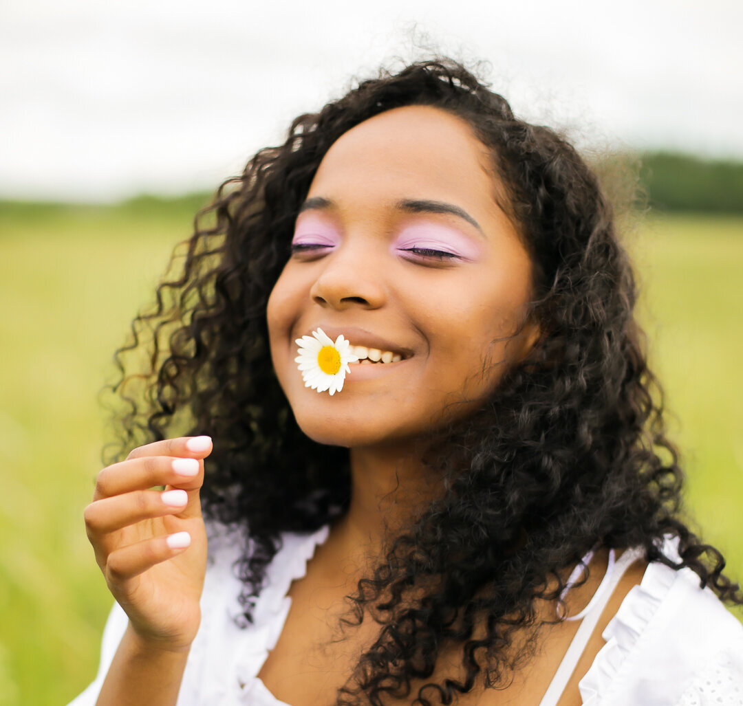 woman with a flower in her mouth