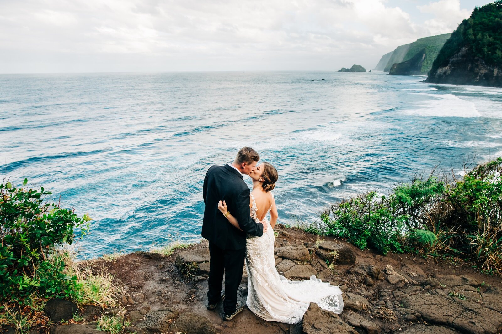 couple on a cliff during their big island wedding