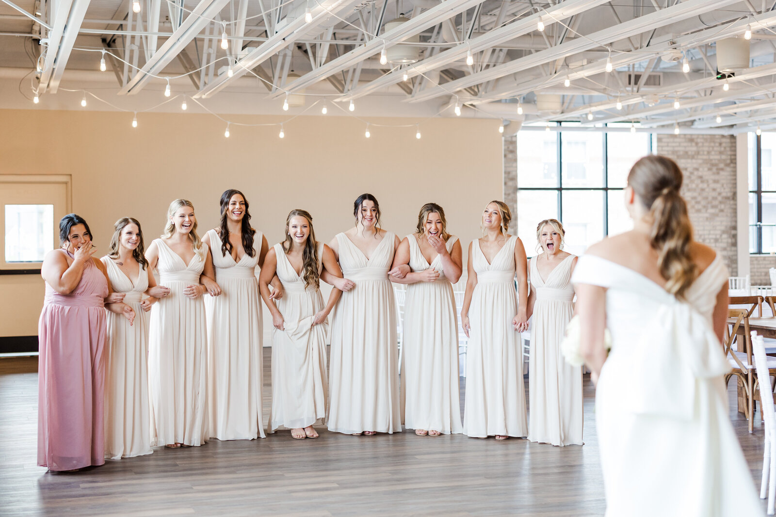 Bride looking at her bridal party for a first look