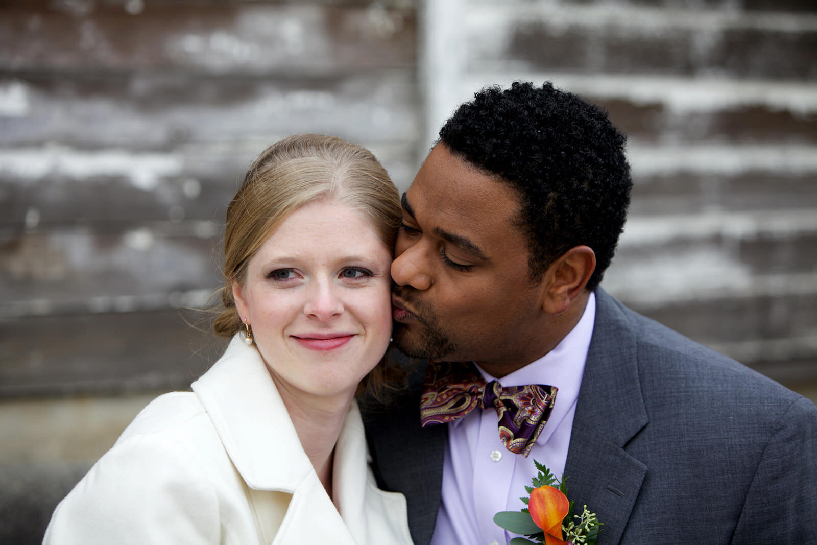 A groom kisses his wife on the cheek during their elopement in Lancaster Pa