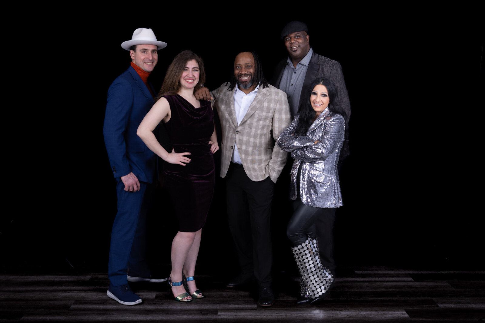 Full Charizma Entertainment DJ team posing together in studio setting with high-energy expressions