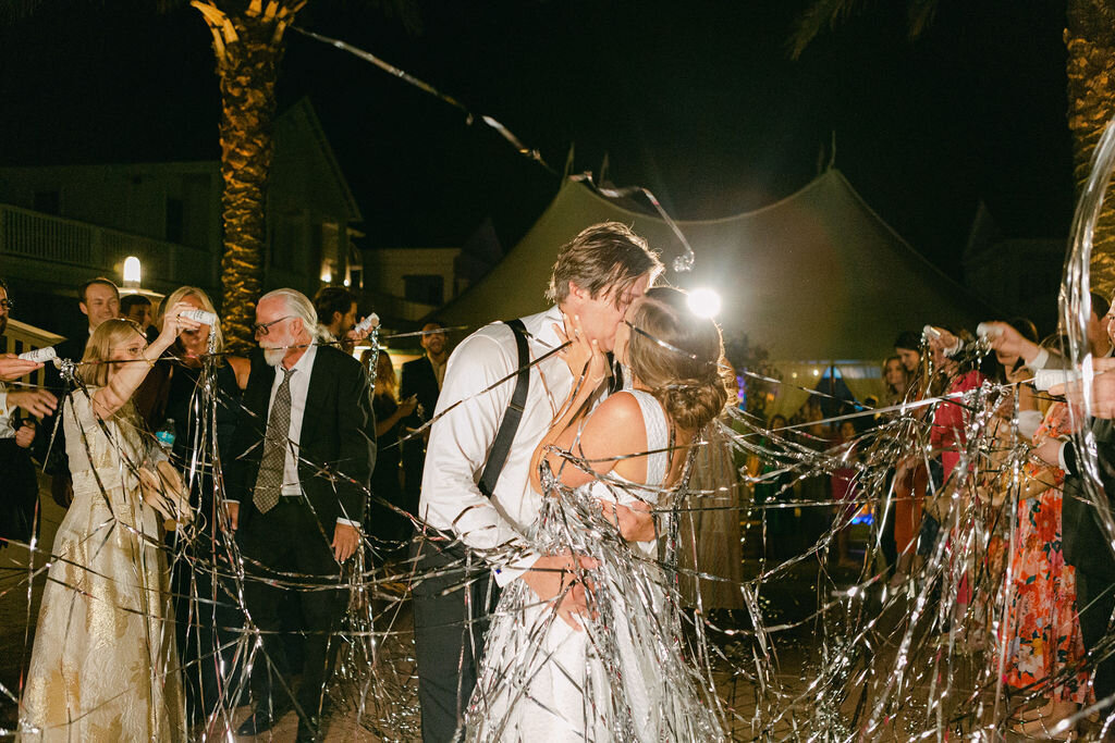 bride and groom kissing at end of wedding reception at santa rosa beach florida
