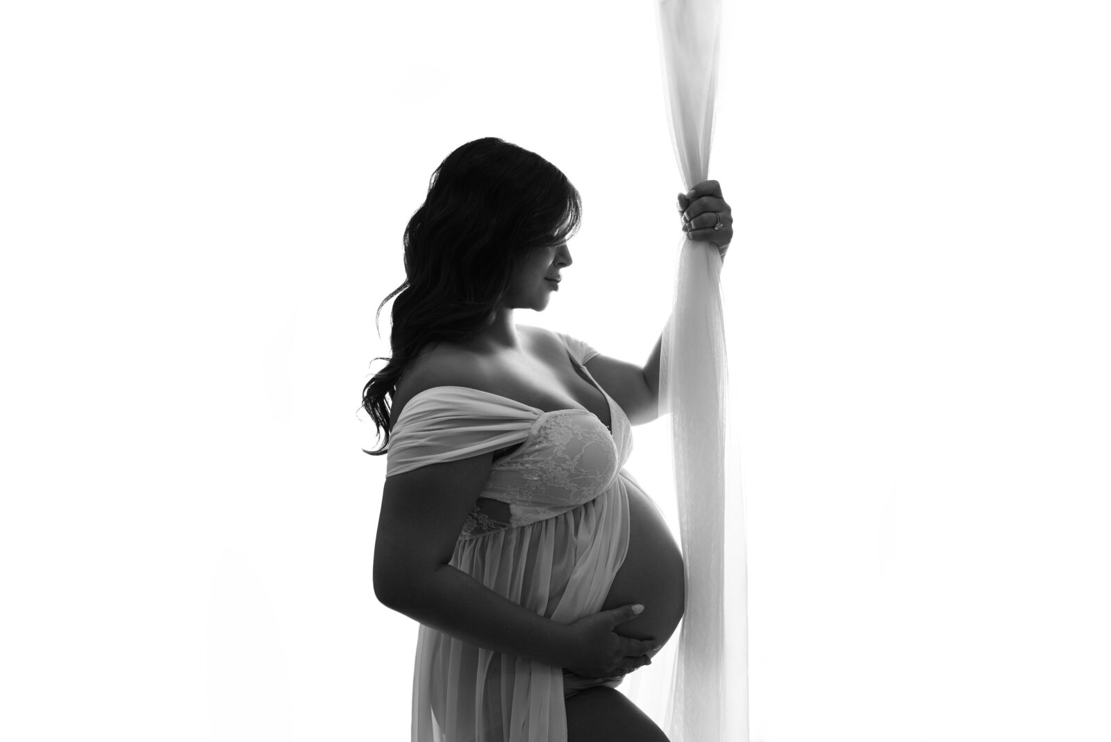 Atlanta, Georgia maternity photography session. Maternity photo shoot with Atlanta, Georgia maternity photographer image in black and white with pregnant woman holding baby bump.