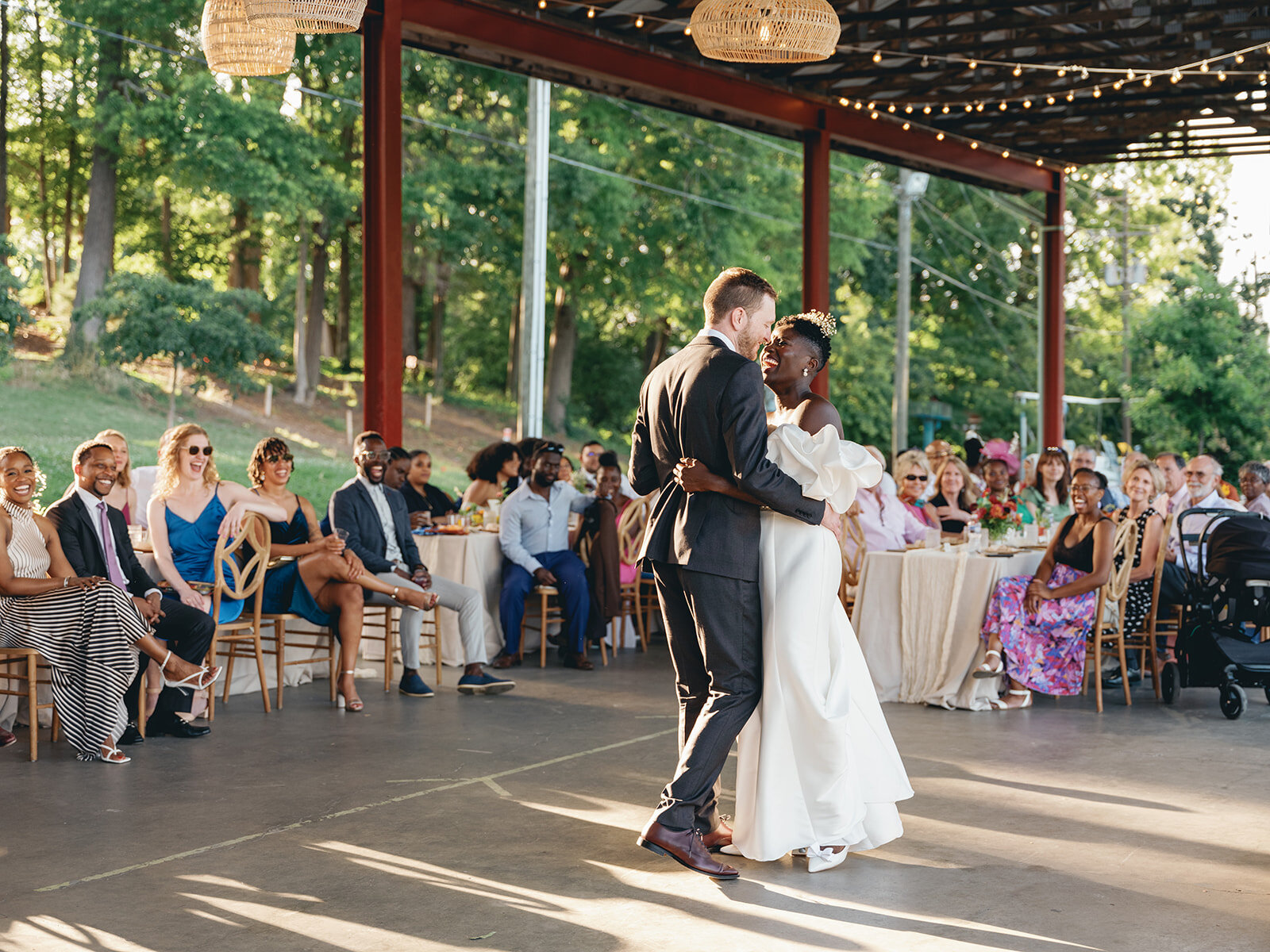 Engaged couple kisses each other at NC Museum of Art