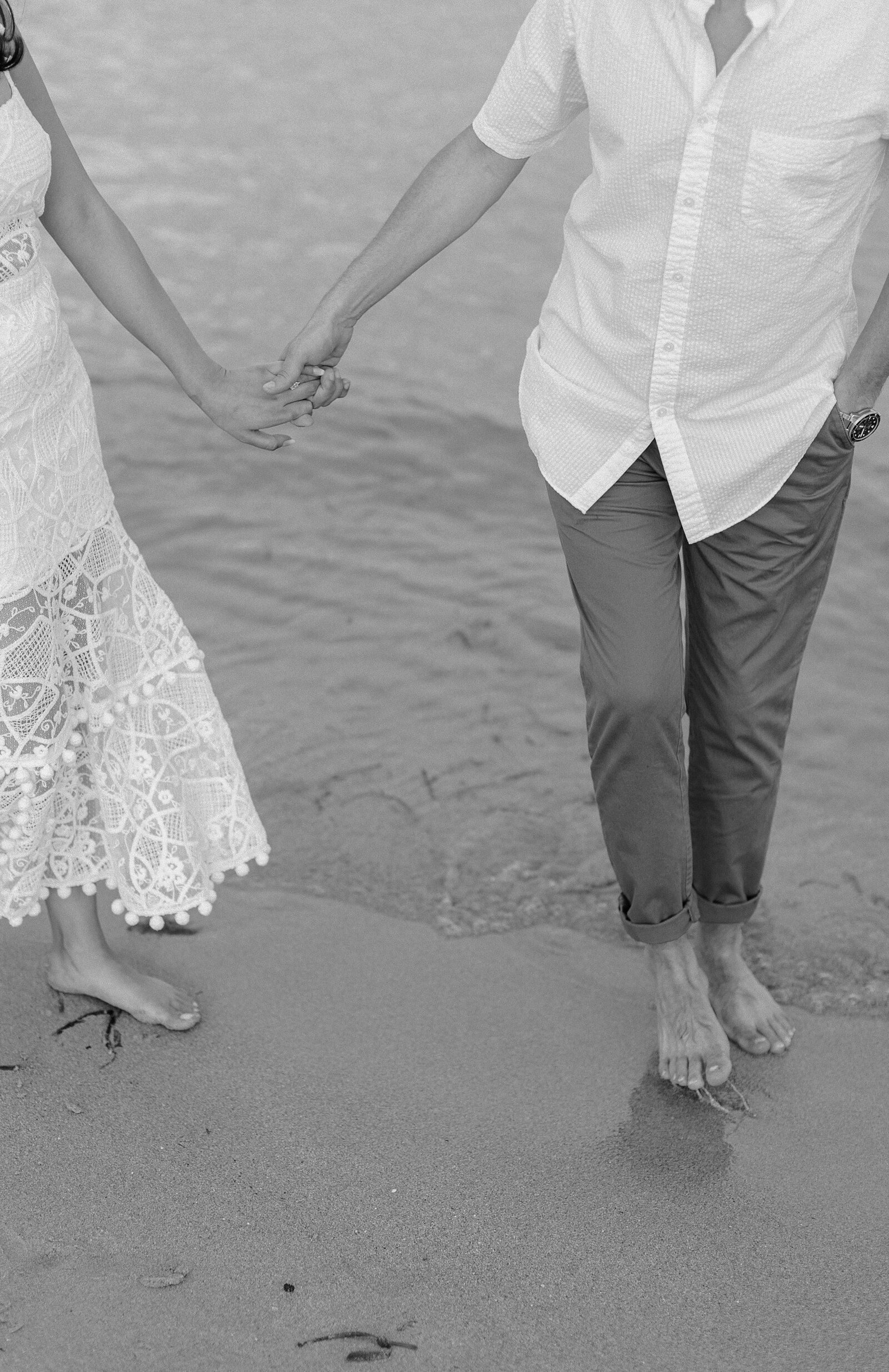 Close up images of couple holding hands on beach in Miami.