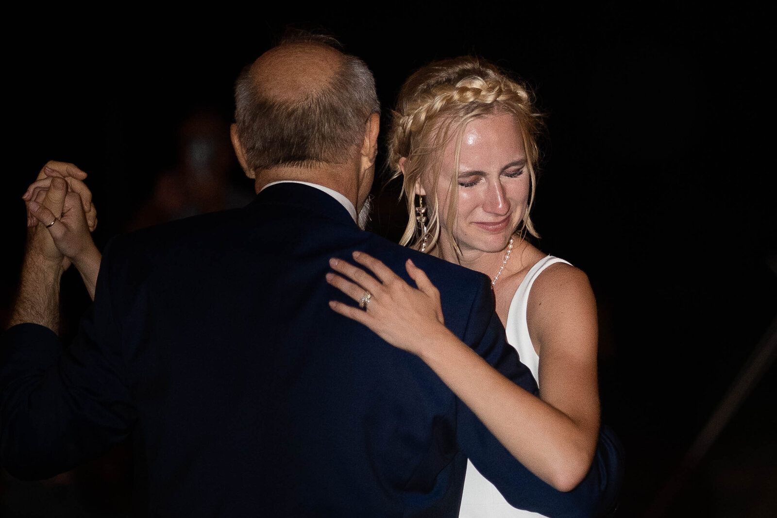 bride and her father dancing as bride hugs her father and leans on his shoulder as a tear strolls down her cheek at the wedding reception by nashville wedding photographer klem photography