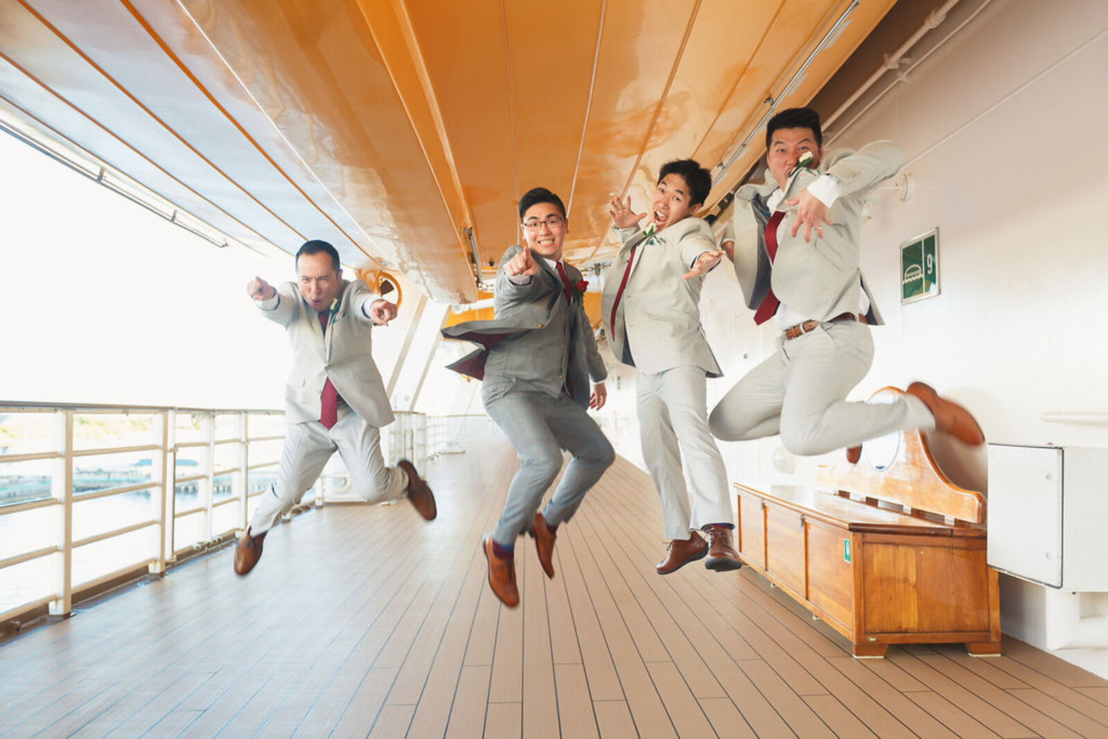Groom and Groomsmen jump photo on deck of the Disney Dream Cruise Ship
