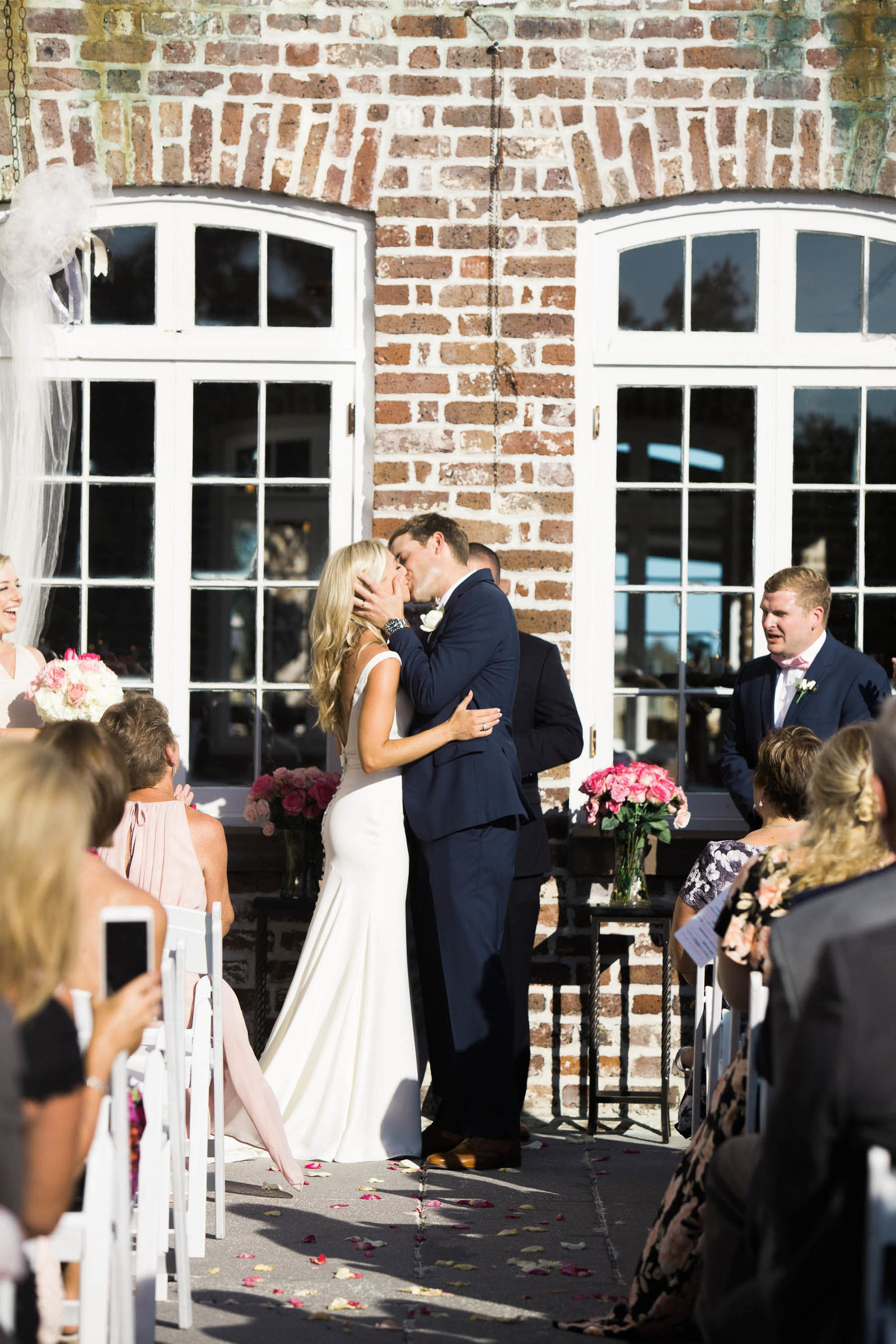 Bride and groom kiss, Rice Mill Building, Charleston, South Carolina