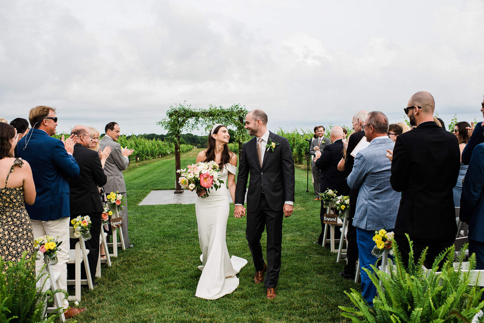 bride and groom recessional down aisle at vineyard