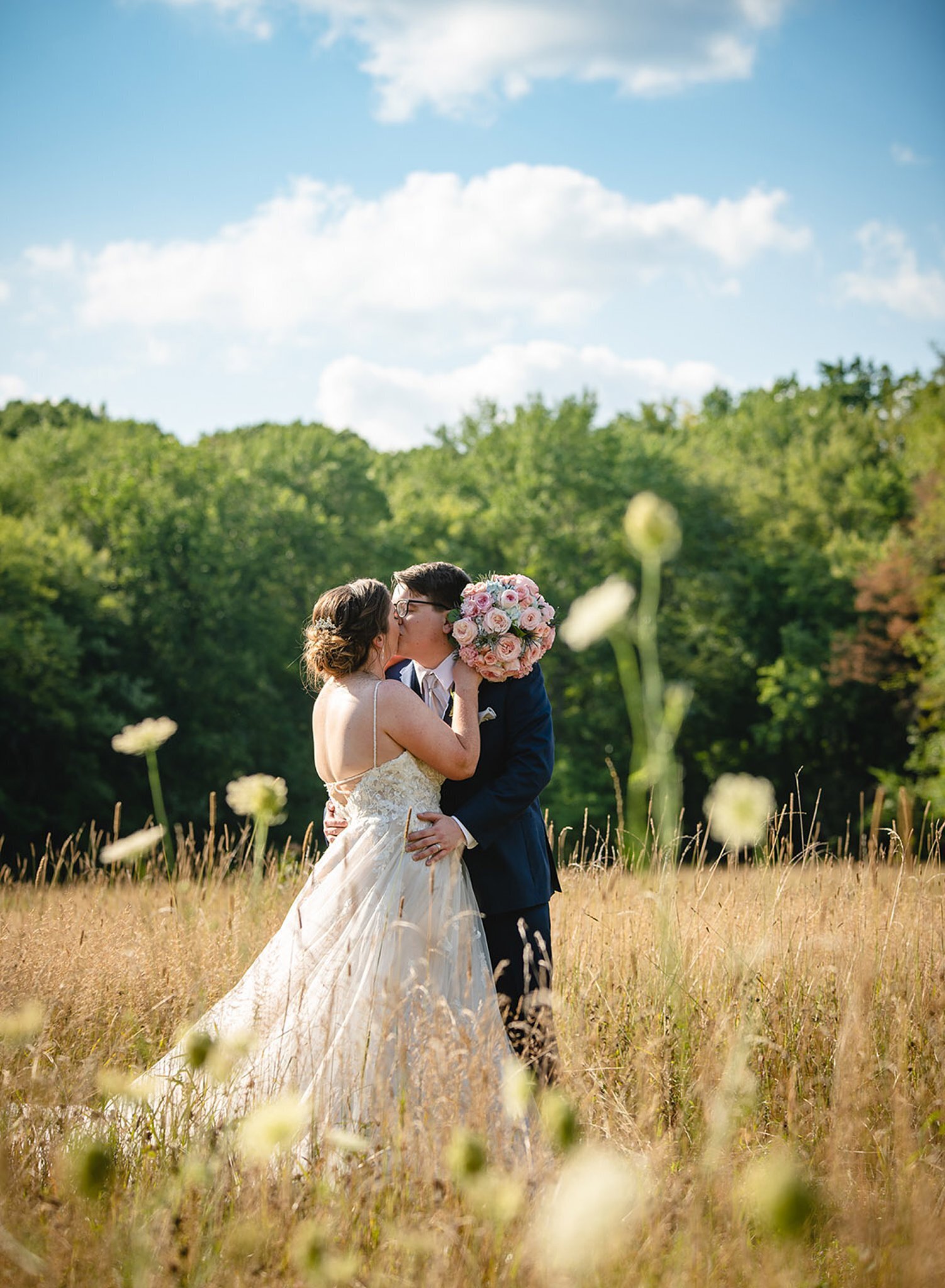 New England elopement couple kissing in wildflower field
