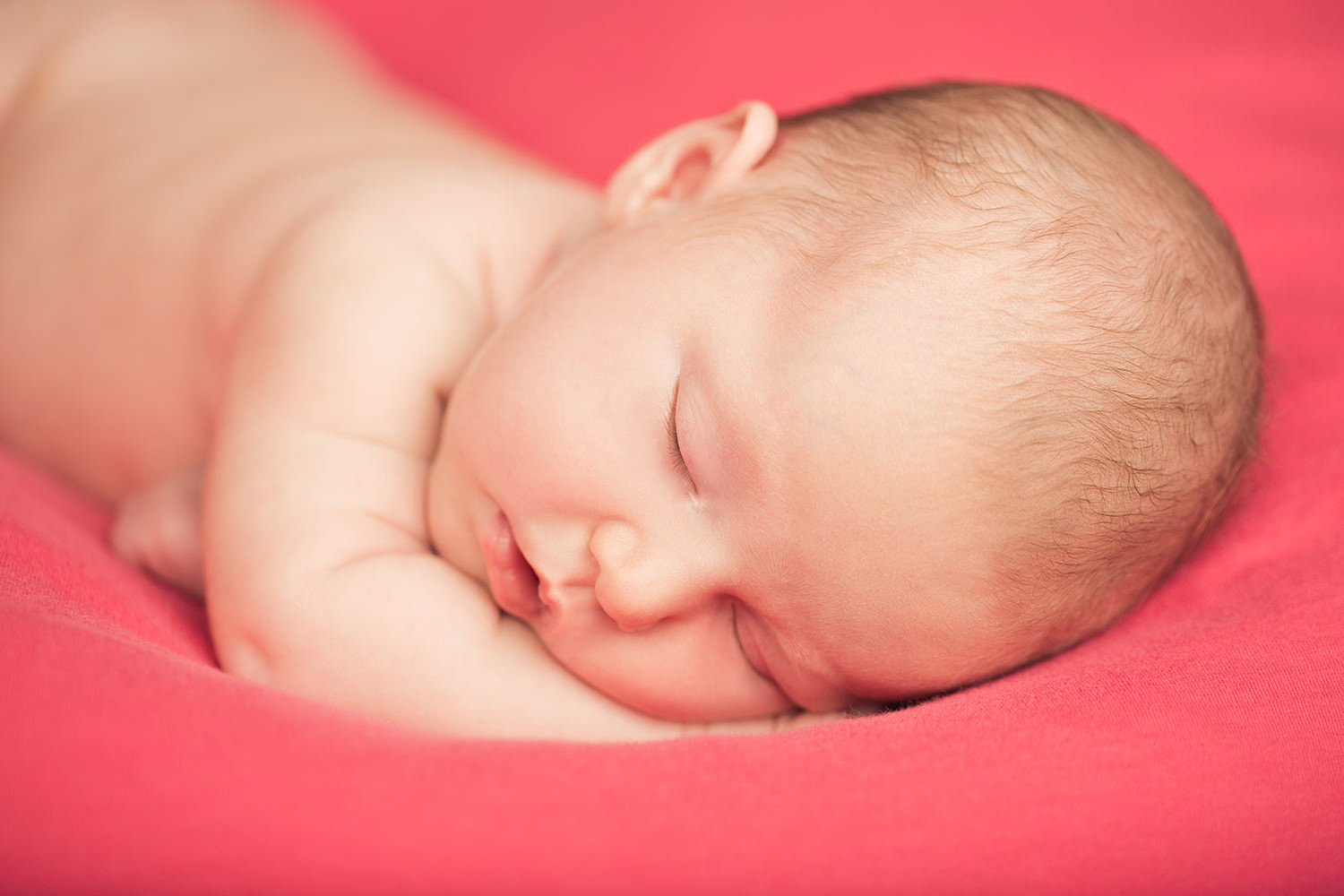 san diego newborn photography | newborn baby girl with pink background sleeping