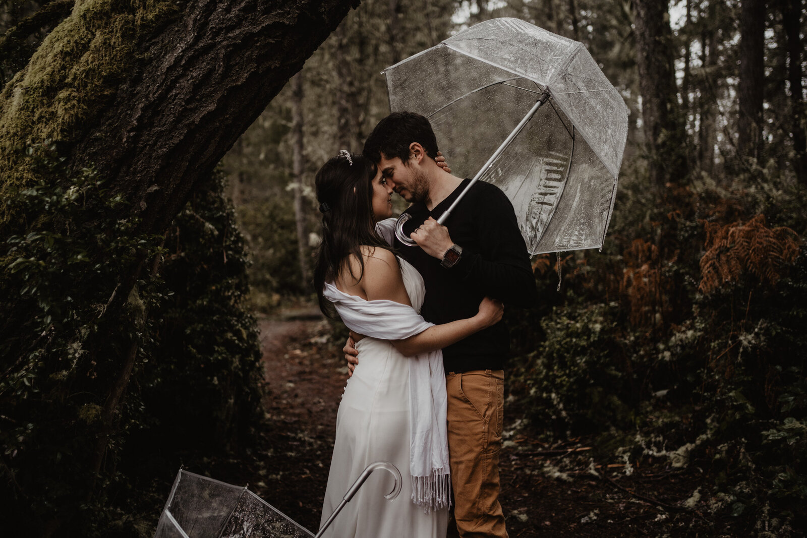 Couple holding umbrella in the rain