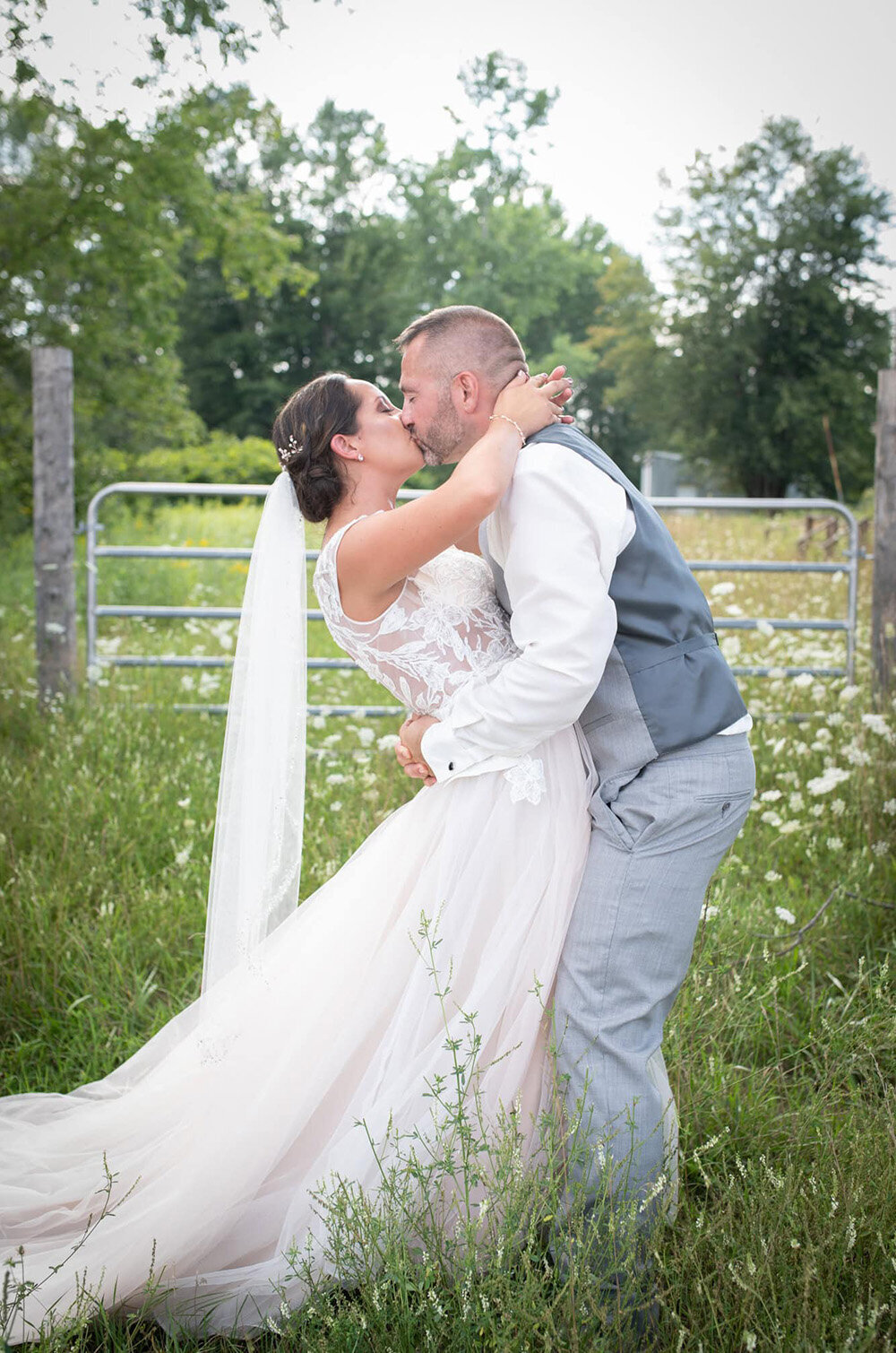couple kiss in wildflower field