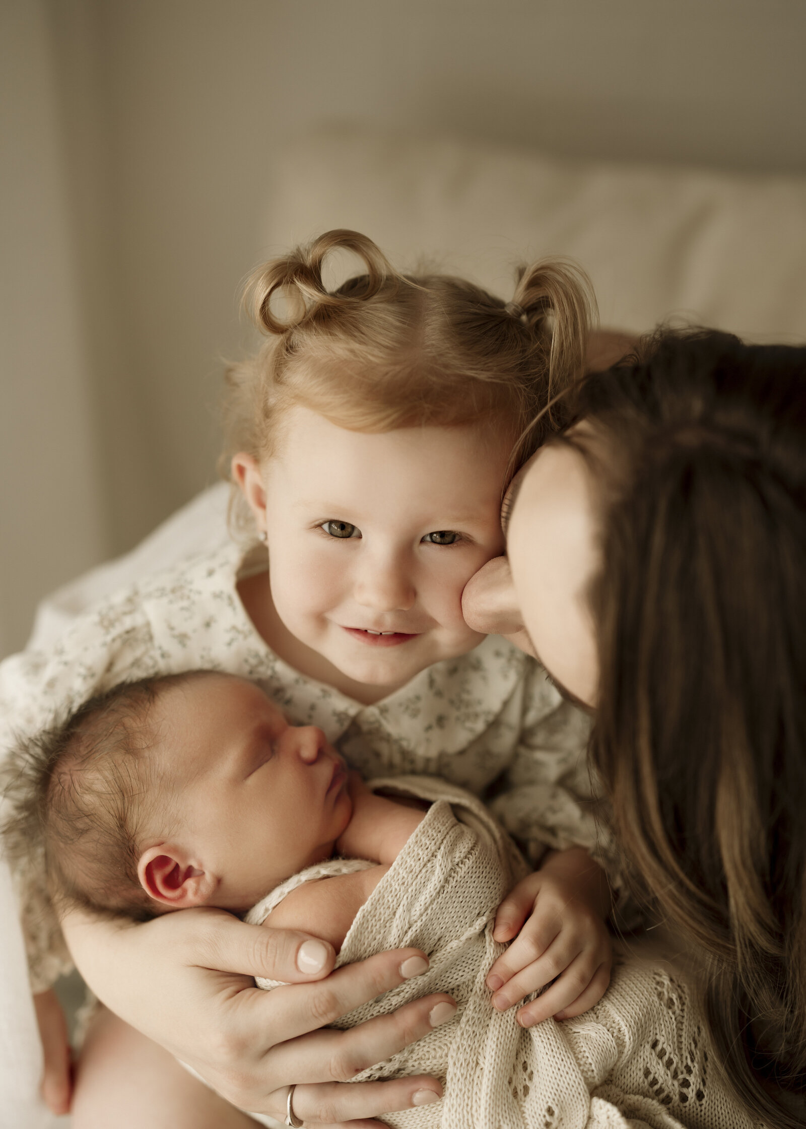 A peaceful and elegant Perth newborn studio photography session, highlighting the bond between baby and parents.